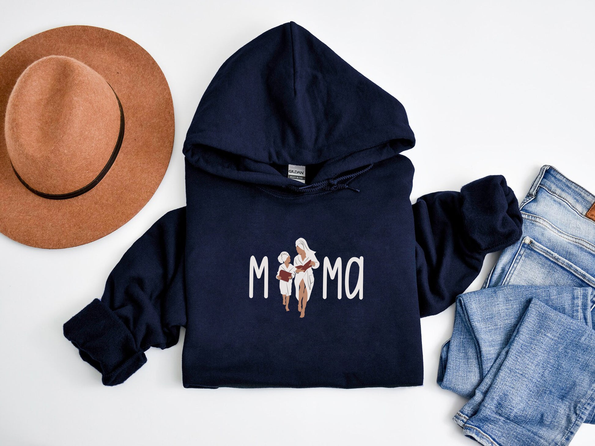 a hoodie, jeans, hat, and a pair of shoes on a white