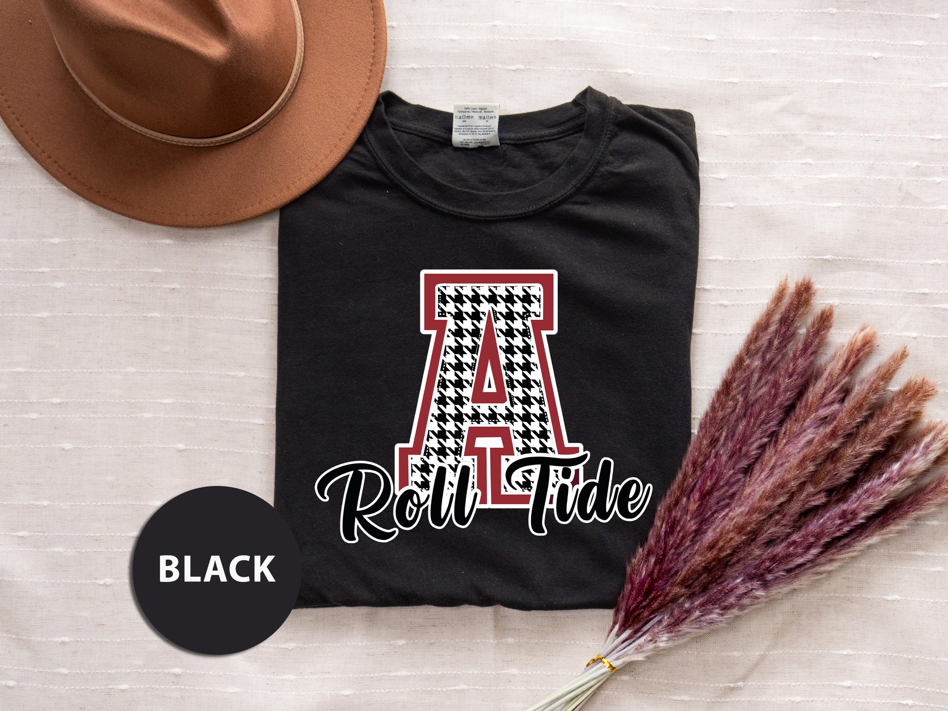 a t - shirt that says roll tide next to a hat