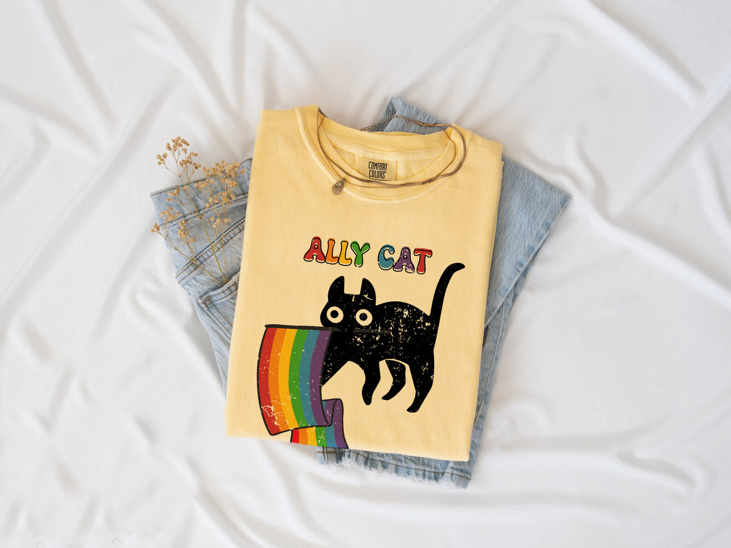 a yellow shirt with a black cat on it