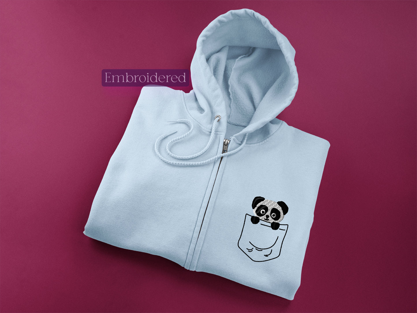 a white zip up hoodie with a panda in a pocket