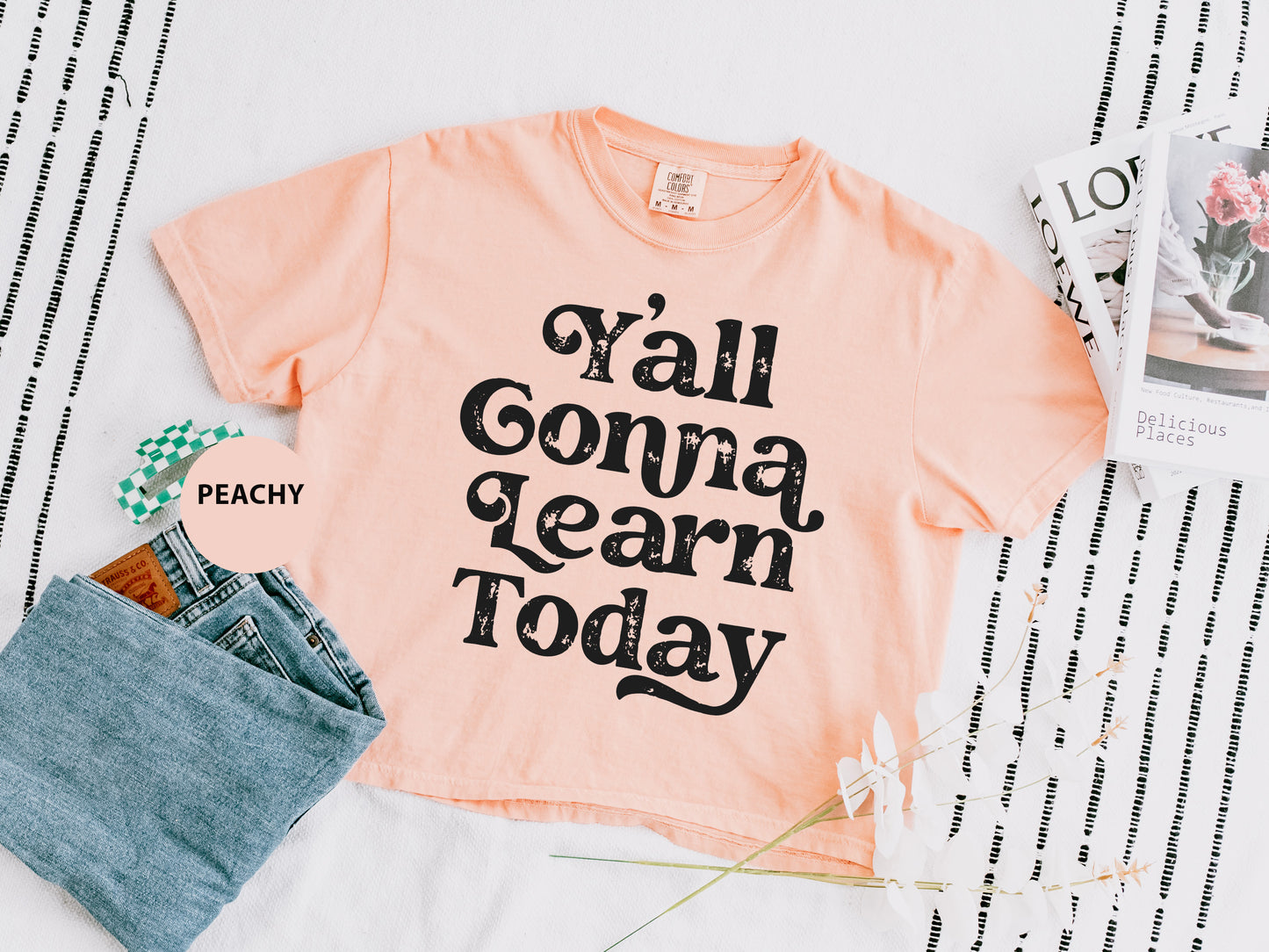 a t - shirt that says y'all gona learn today next to a