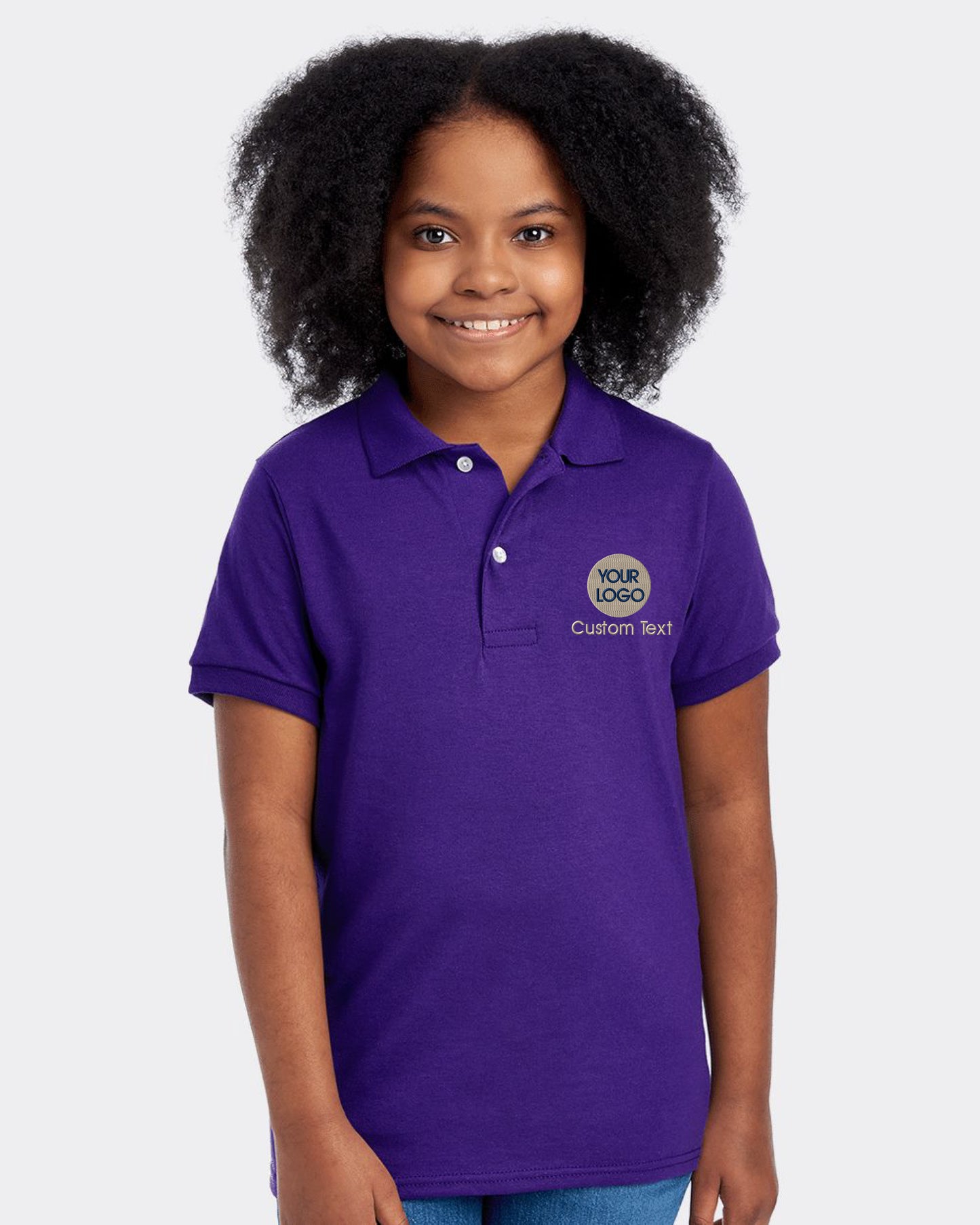 a young girl wearing a purple shirt and smiling