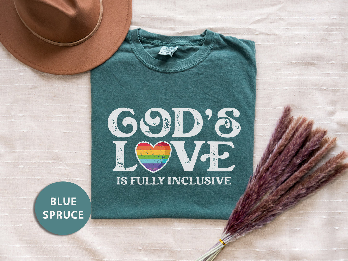 a t - shirt that says god's love is fully inclusive with a straw
