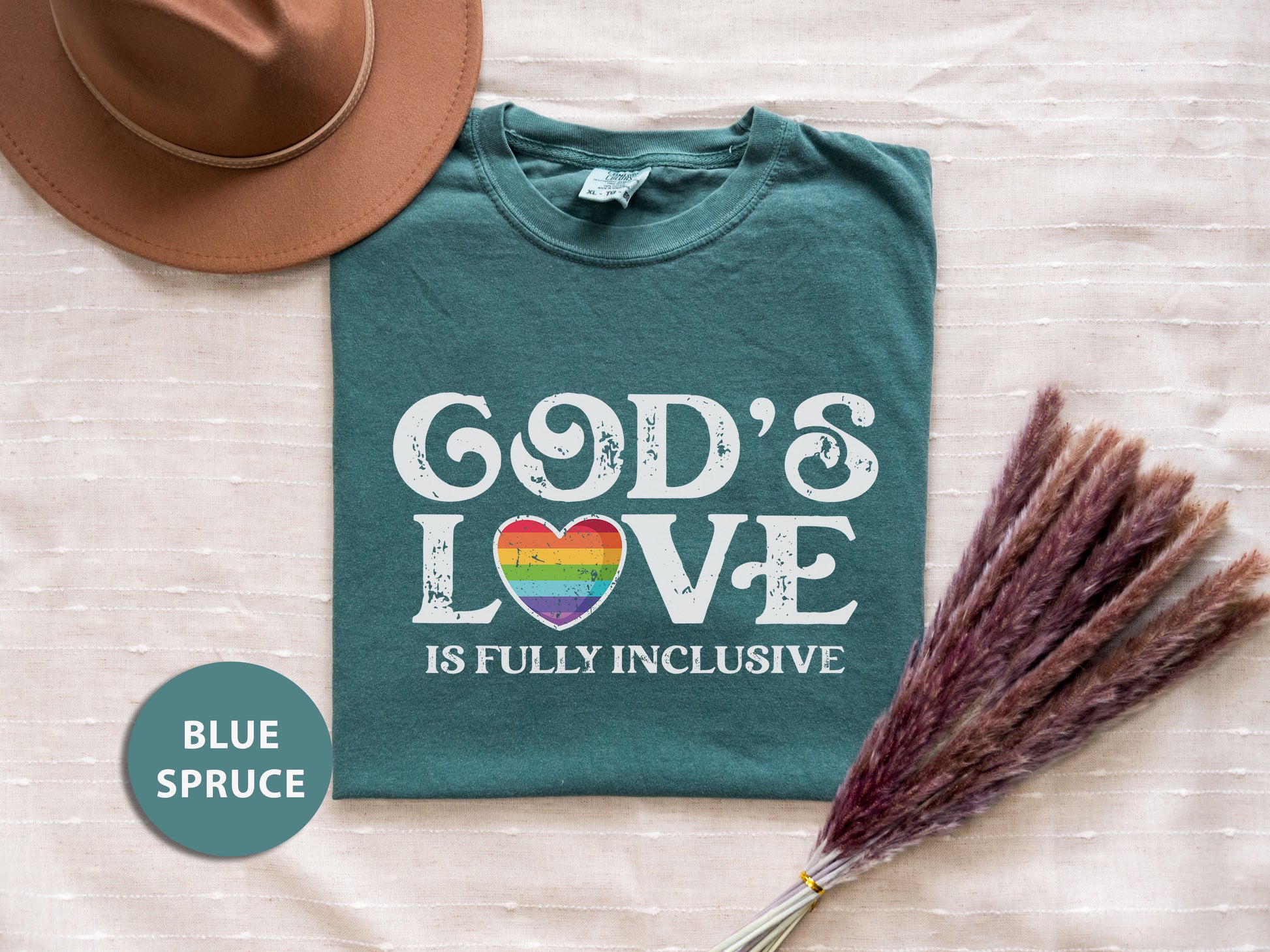 a t - shirt that says god's love is fully inclusive with a straw