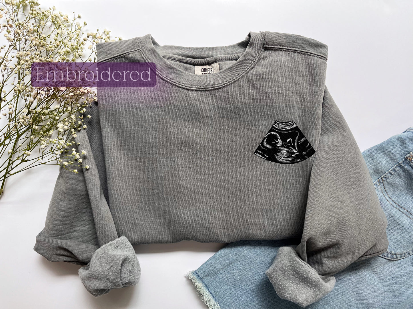 a gray sweatshirt with a black cat on it