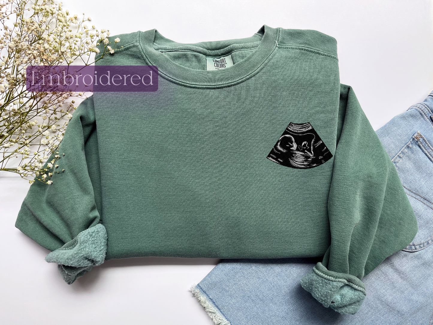 a green sweatshirt with a black cat on it