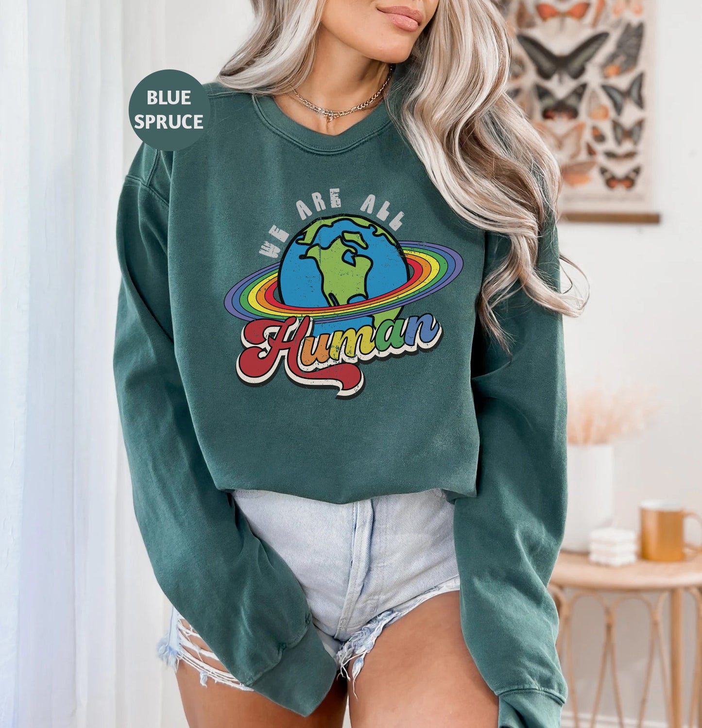 a woman wearing a green sweatshirt and shorts