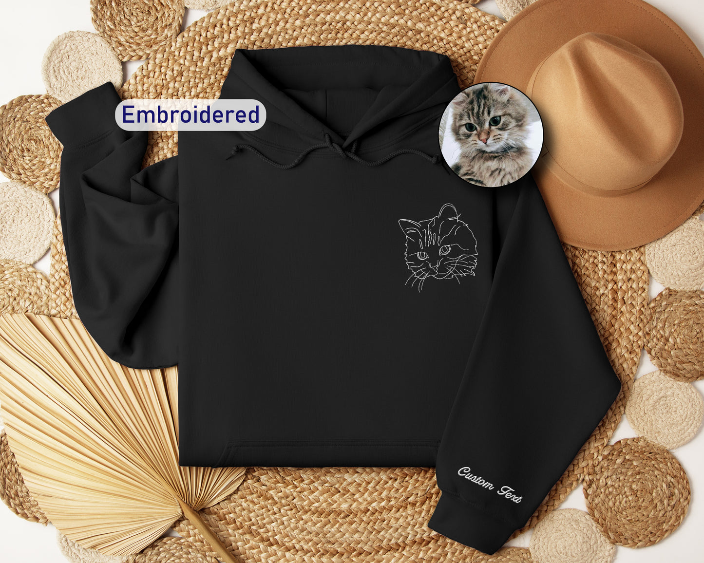 a black hoodie with a picture of a cat on it