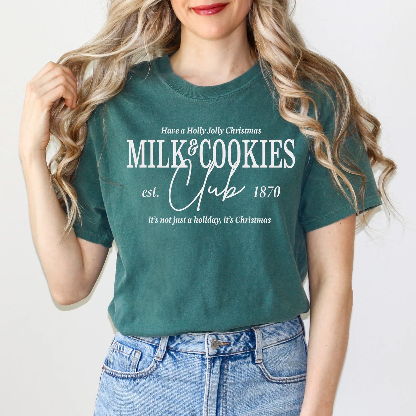 a woman wearing a green milk and cookies t - shirt