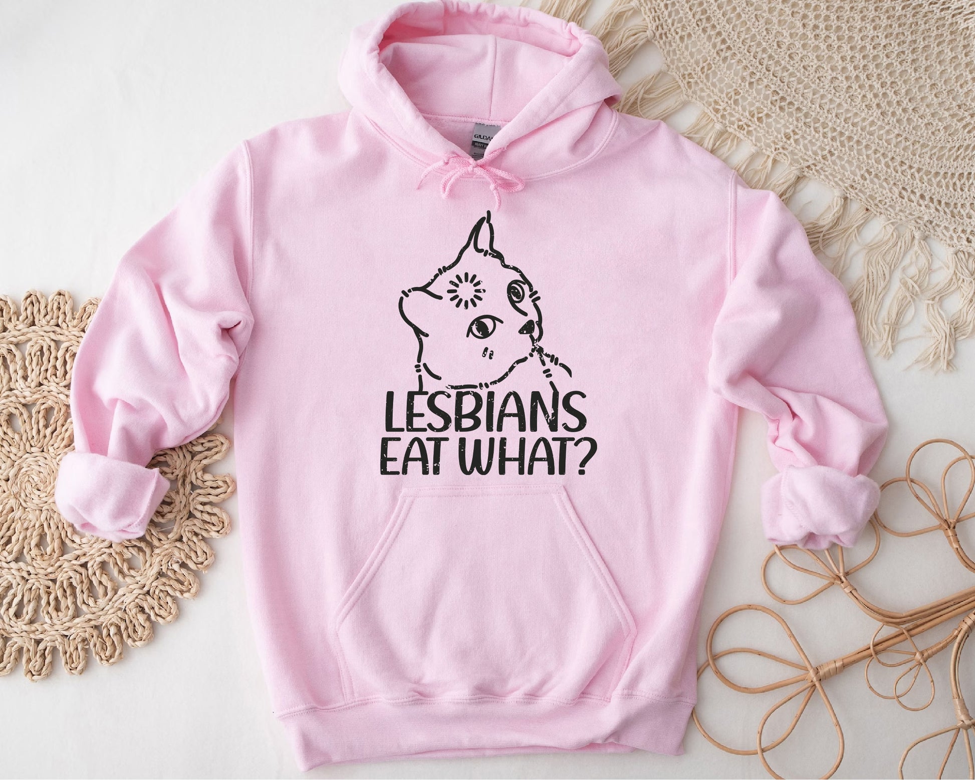 a pink hoodie with the words lesbians eat what on it