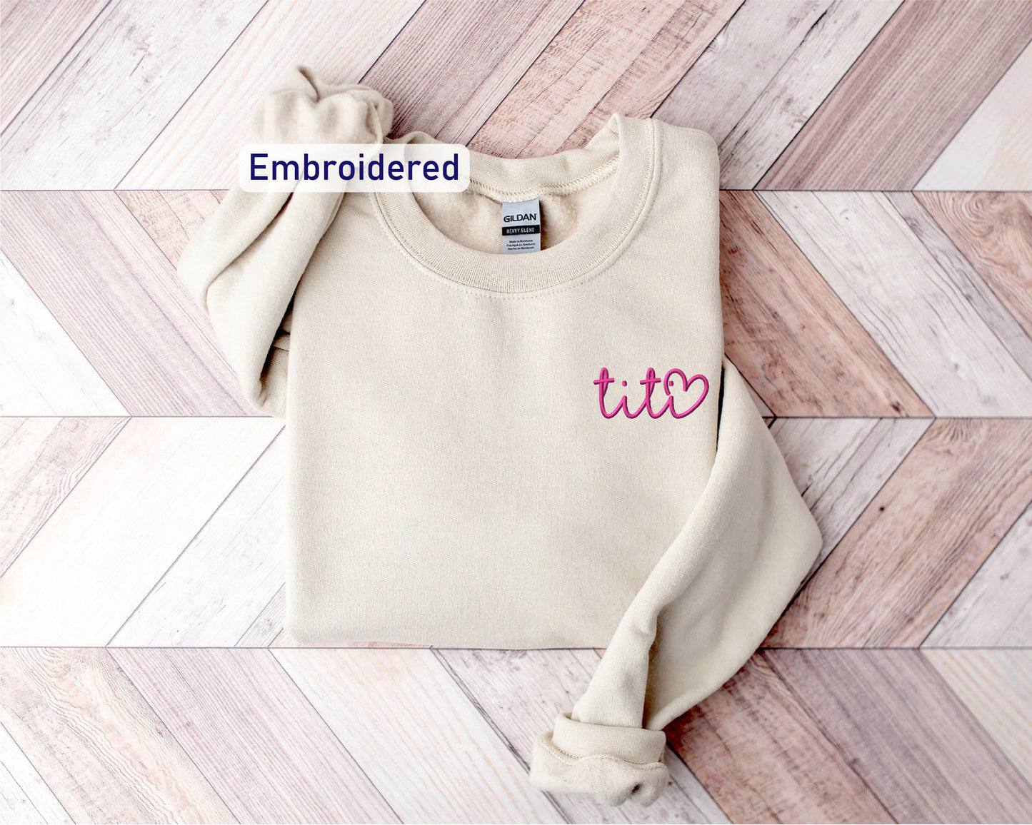 a white sweater with the word embroidered on it