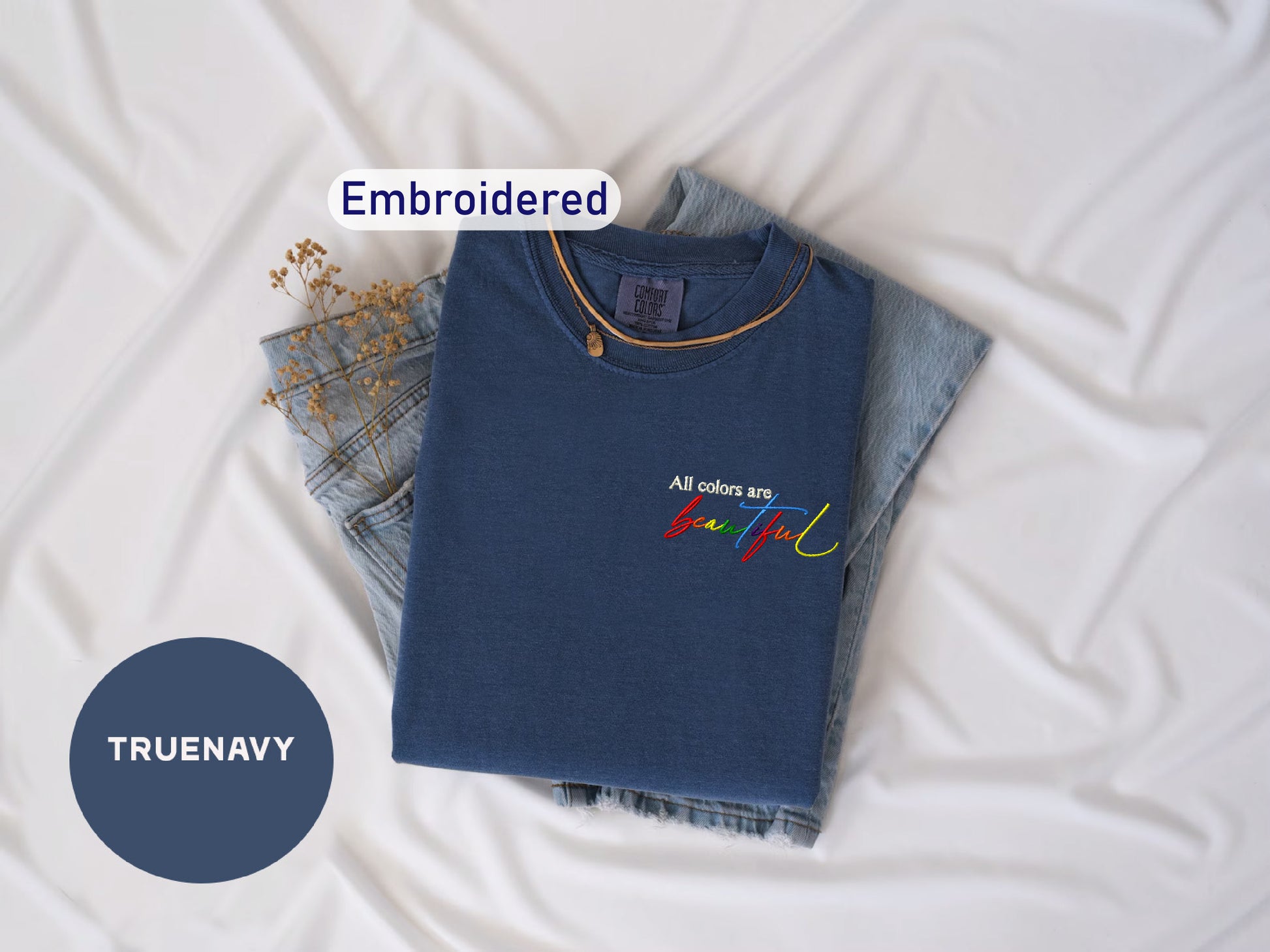 a t - shirt and jeans laying on a bed