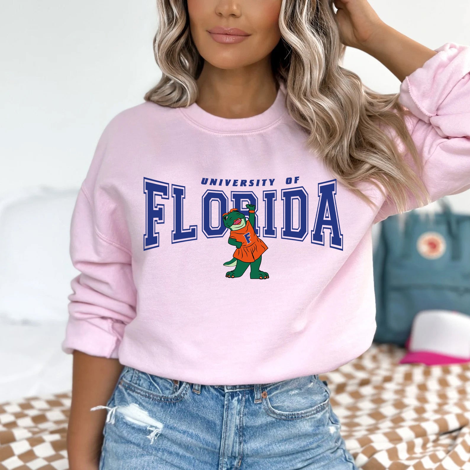 a woman wearing a pink sweatshirt with the university of florida on it