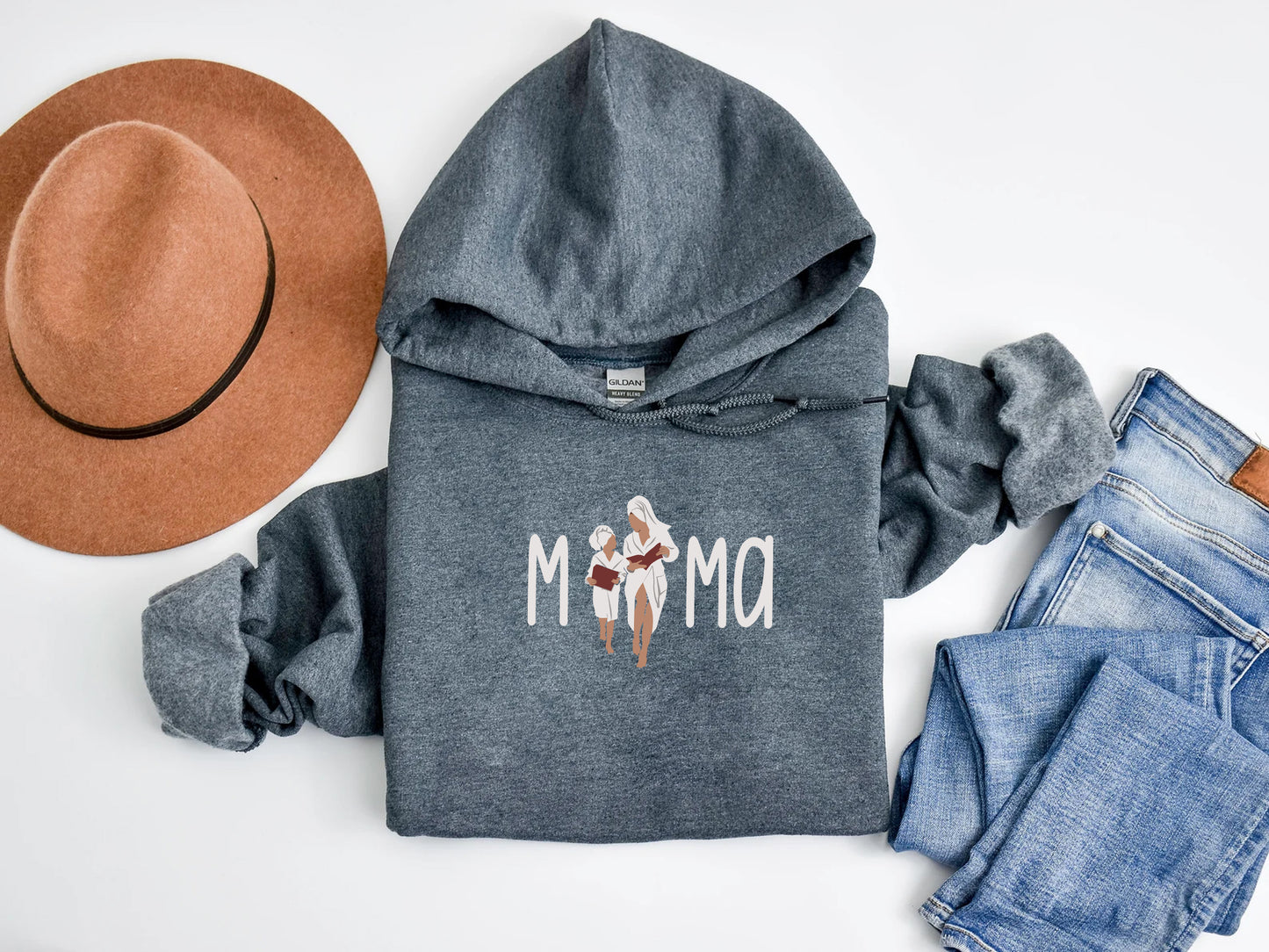 a hoodie, jeans, hat, and a pair of shoes on a white