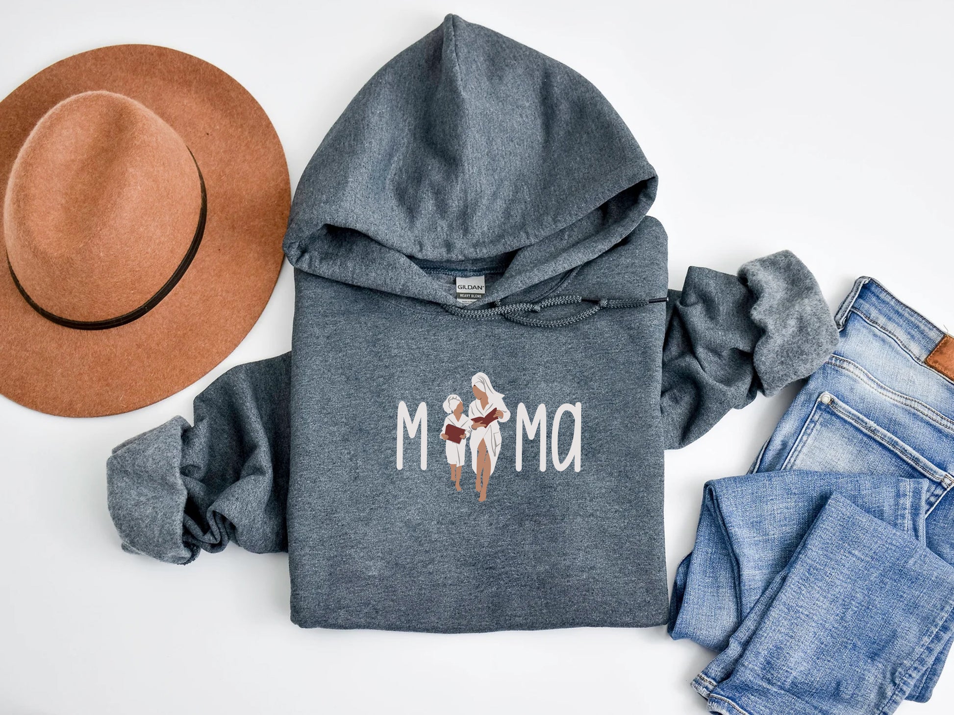 a hoodie, jeans, hat, and a pair of shoes on a white