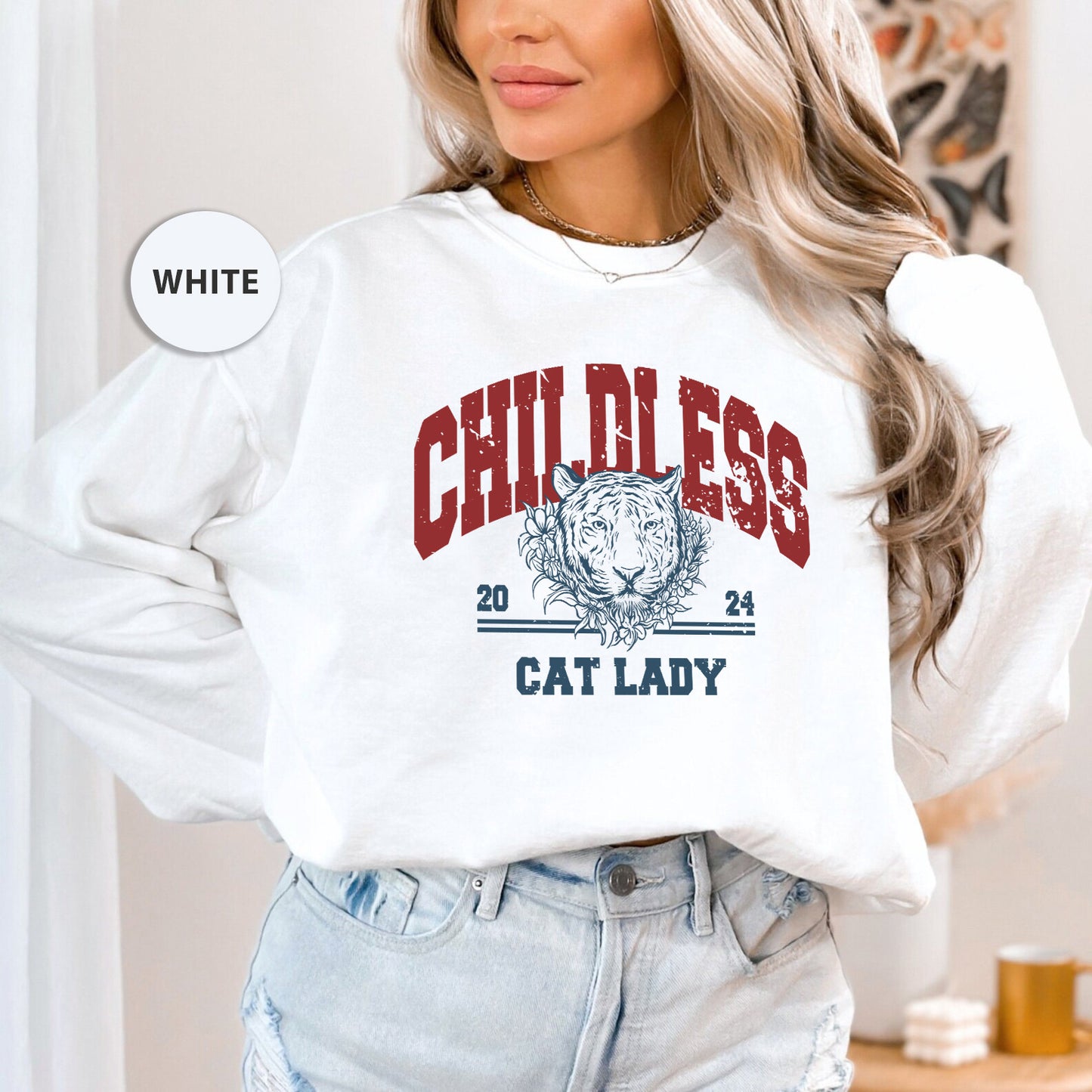 a woman wearing a white sweatshirt with a cat lady on it