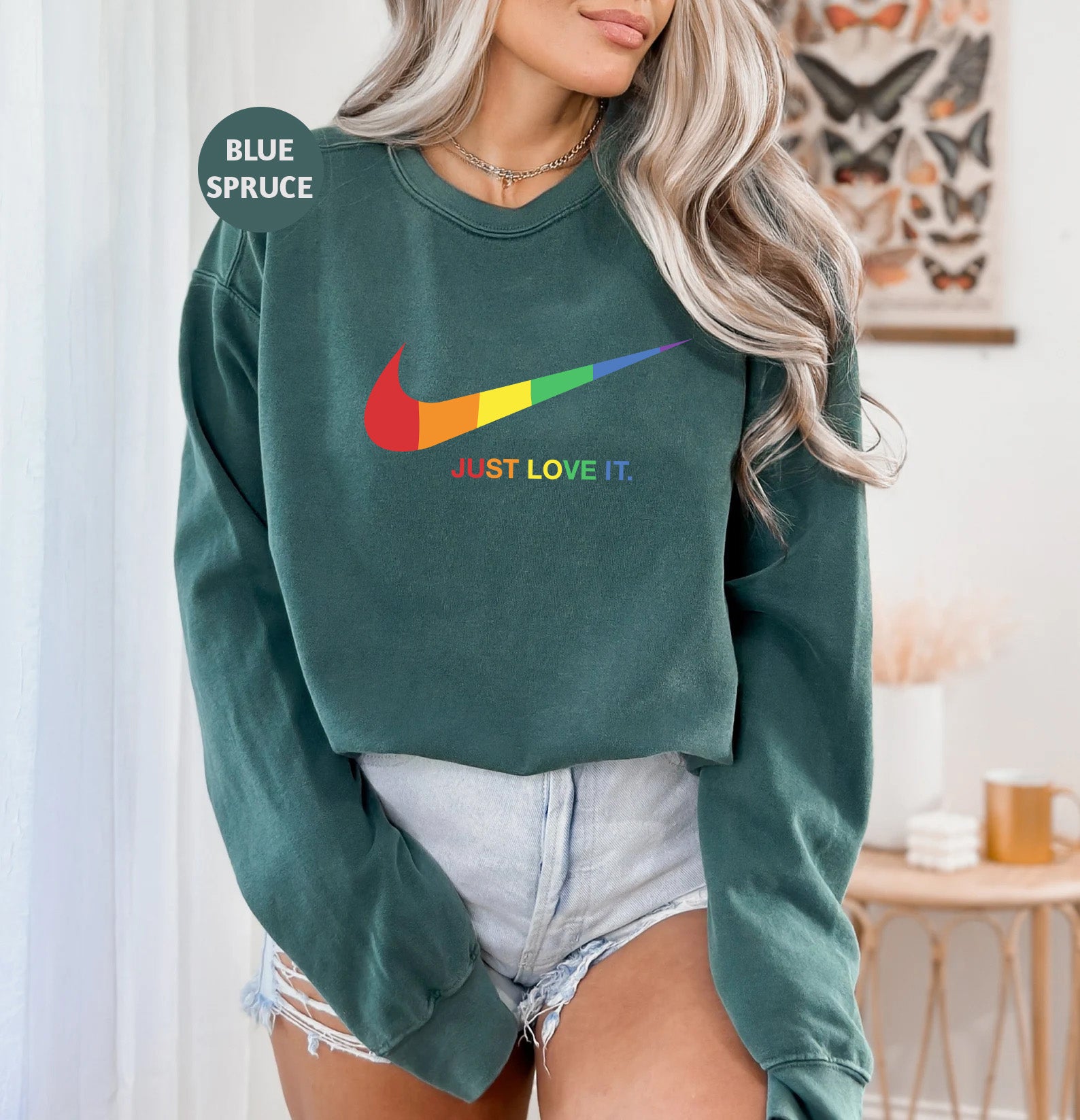 a woman wearing a green sweatshirt with the slogan just love it