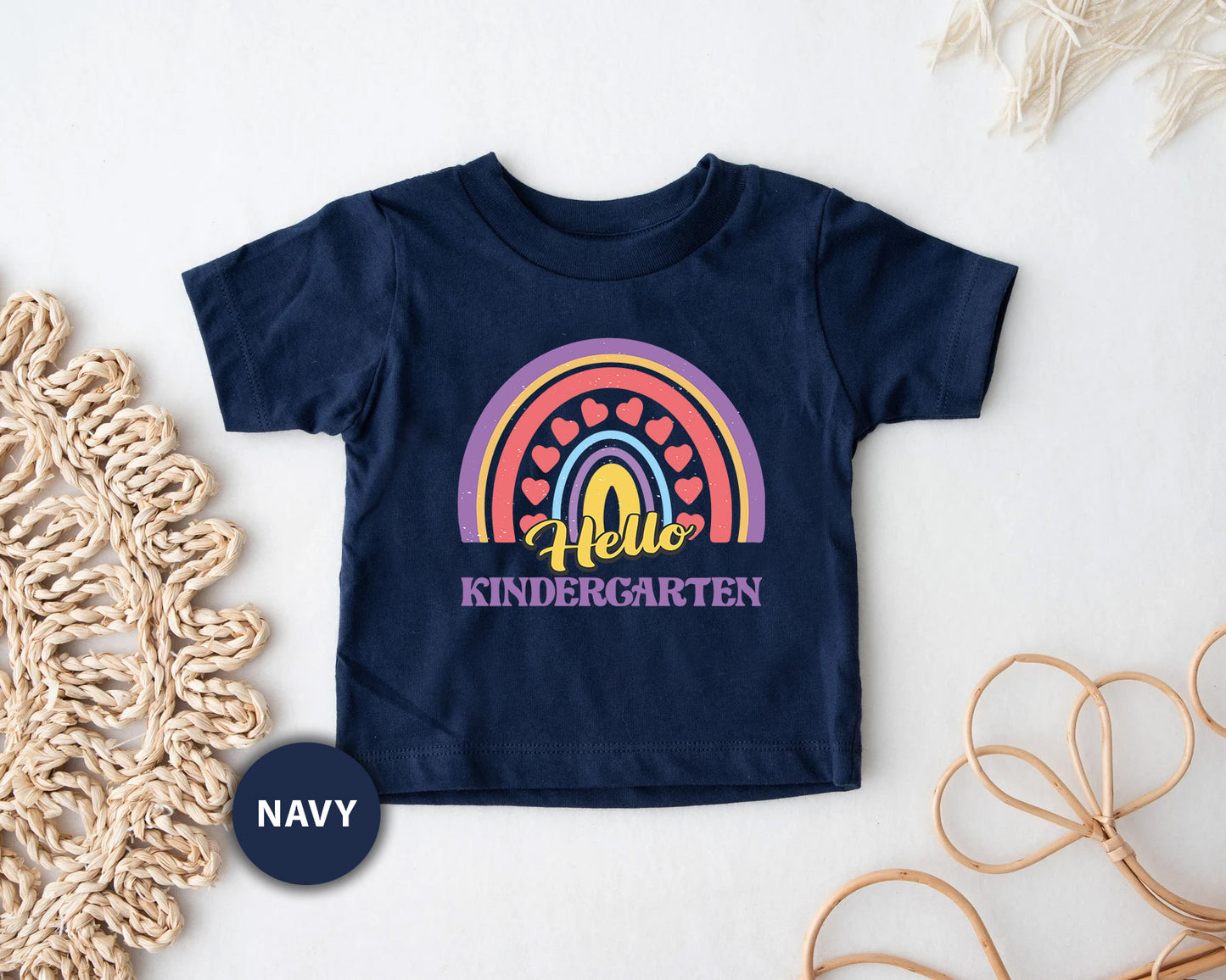 a child's t - shirt with the word hello, and a rainbow on