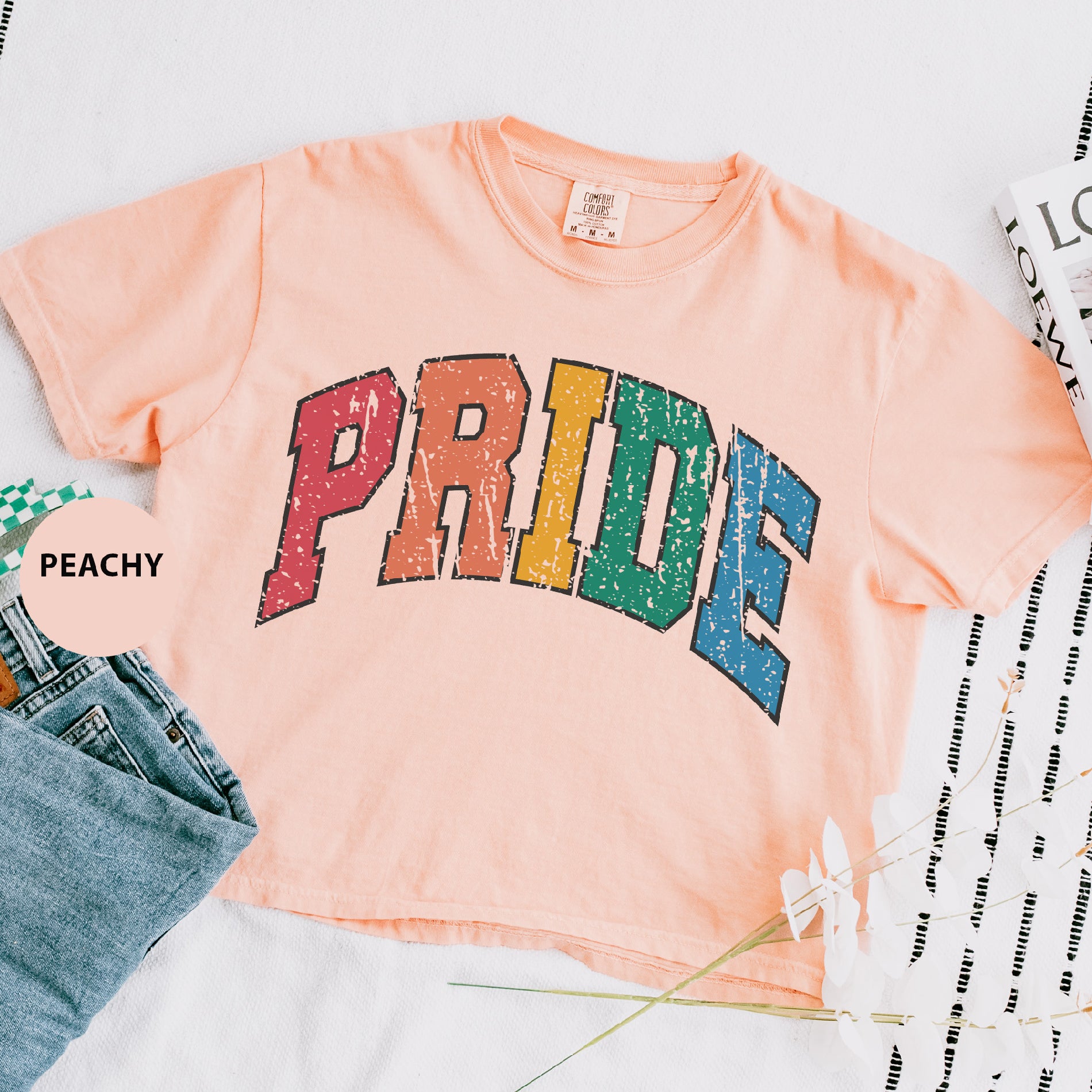a pink shirt with the word pride on it