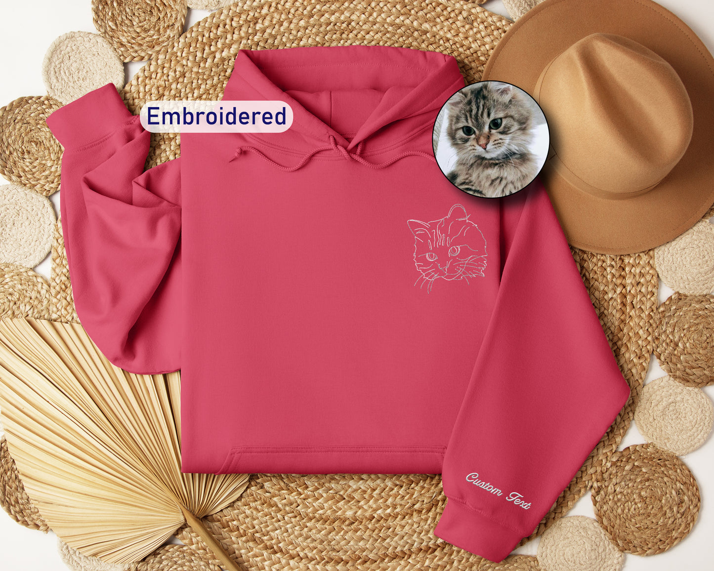 a pink hoodie with a picture of a cat on it