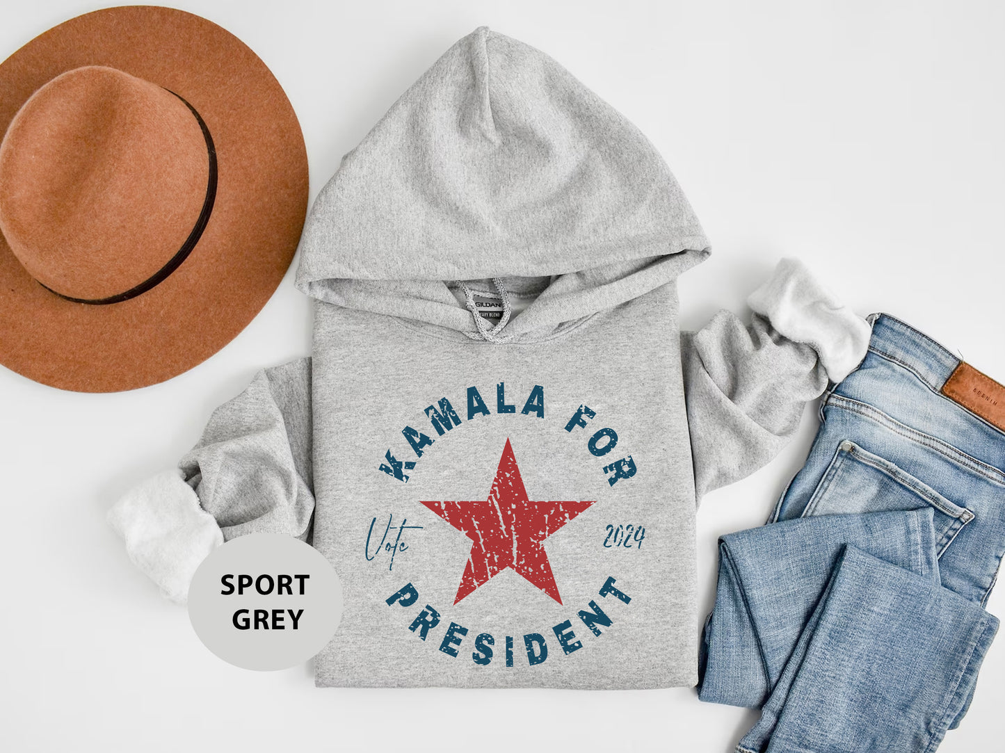 a gray sweatshirt with a red star and a brown hat
