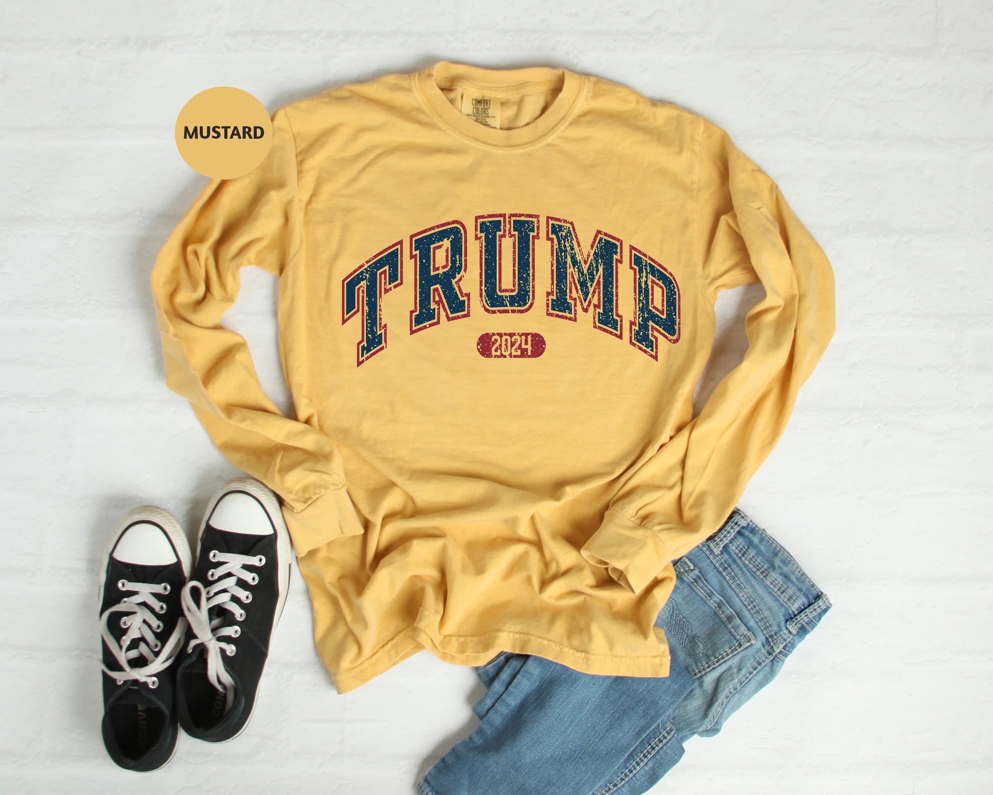 a pair of black sneakers and a yellow shirt with the word trump on it