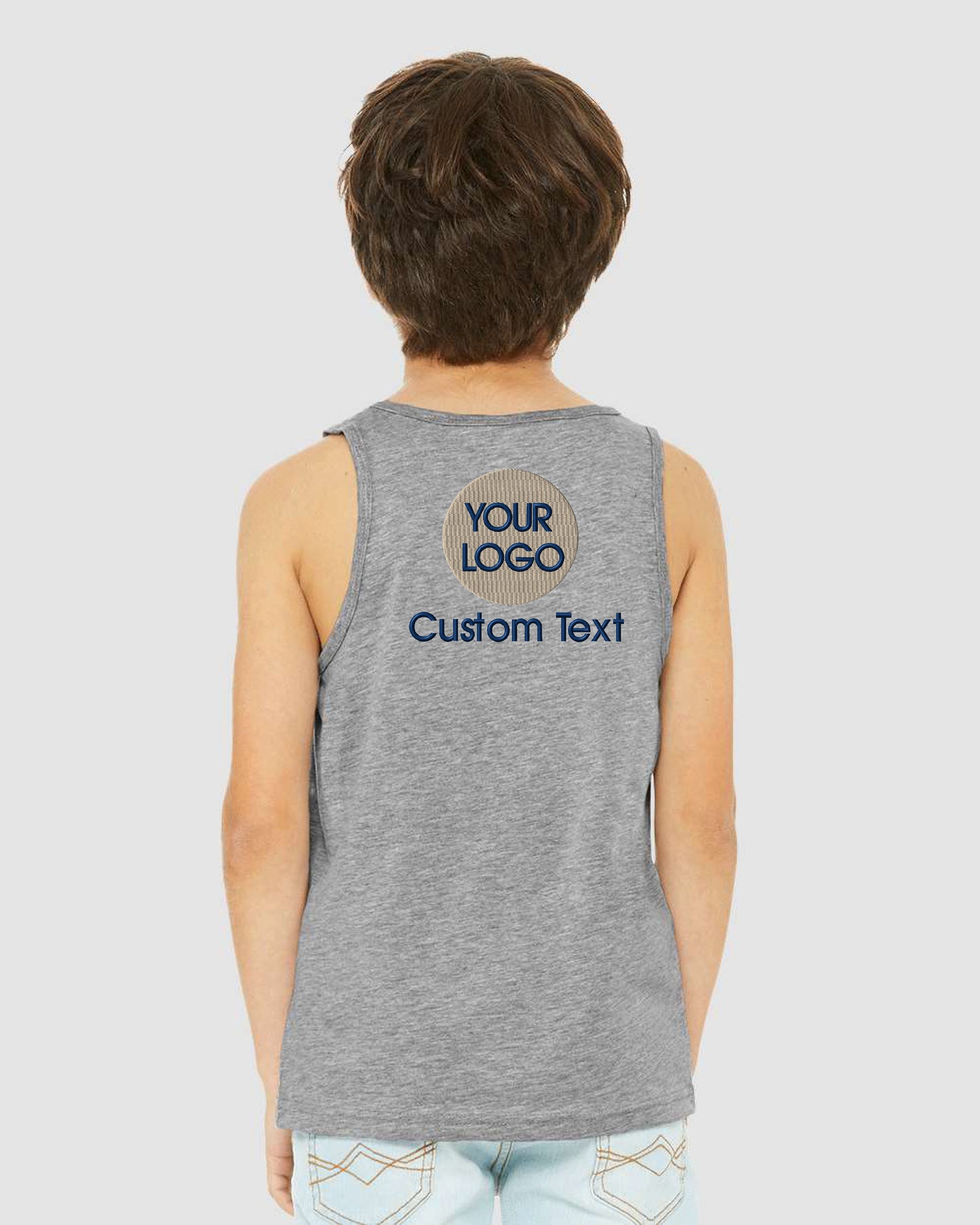 a young boy wearing a grey tank top with a custom text