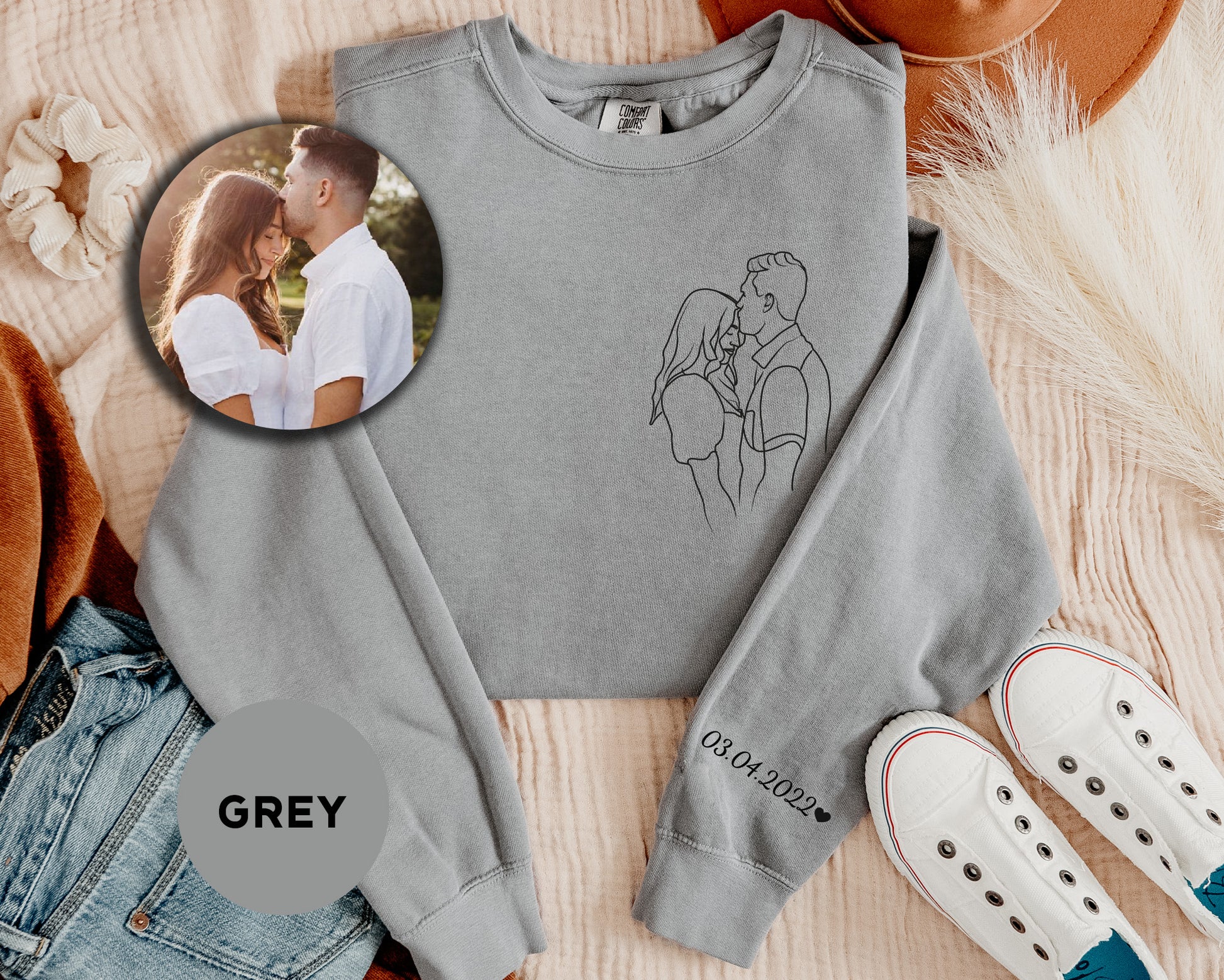 a grey sweatshirt with a picture of a couple on it