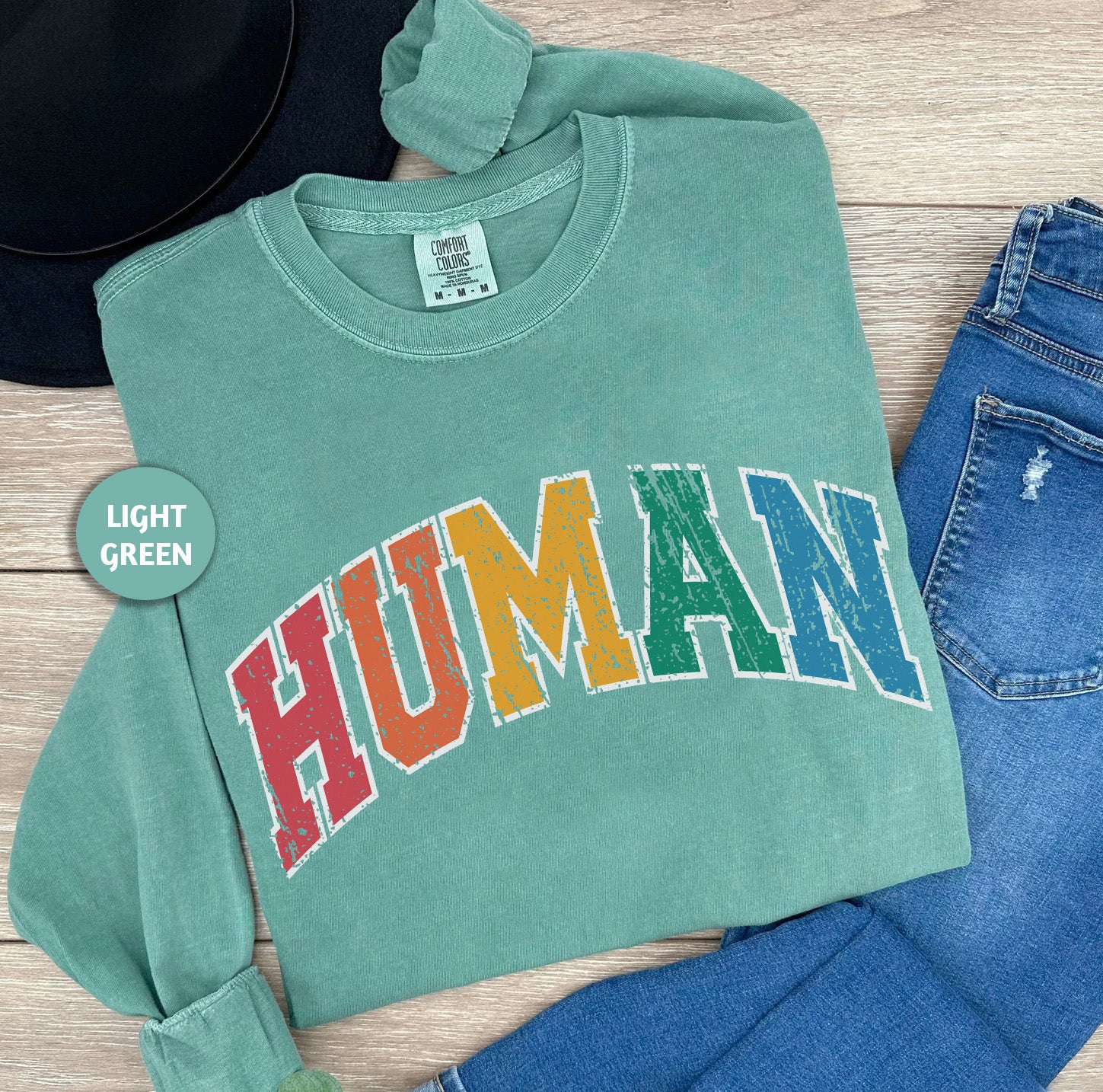 a green shirt with the word human printed on it