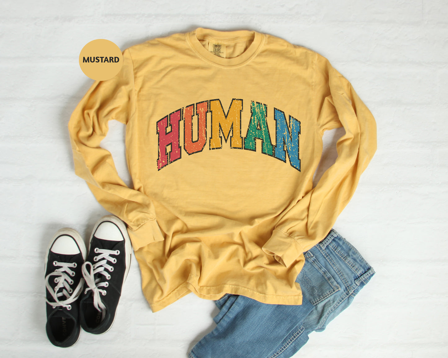 a yellow shirt with the word human on it