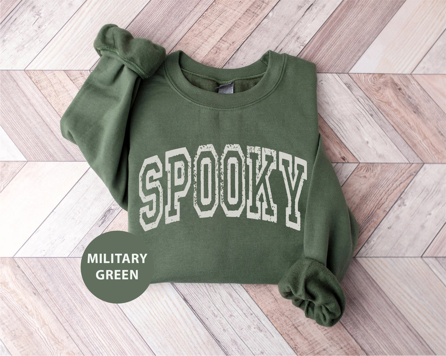 a green sweatshirt with the word spooky printed on it