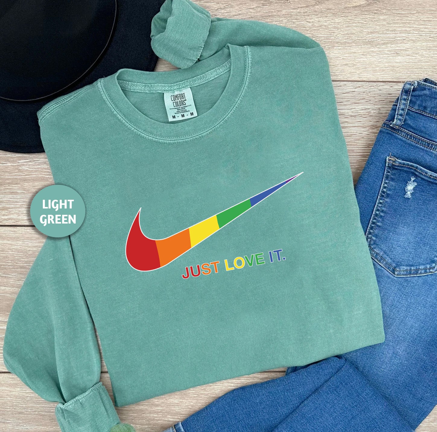 a pair of jeans, a hat, and a t - shirt on a wooden