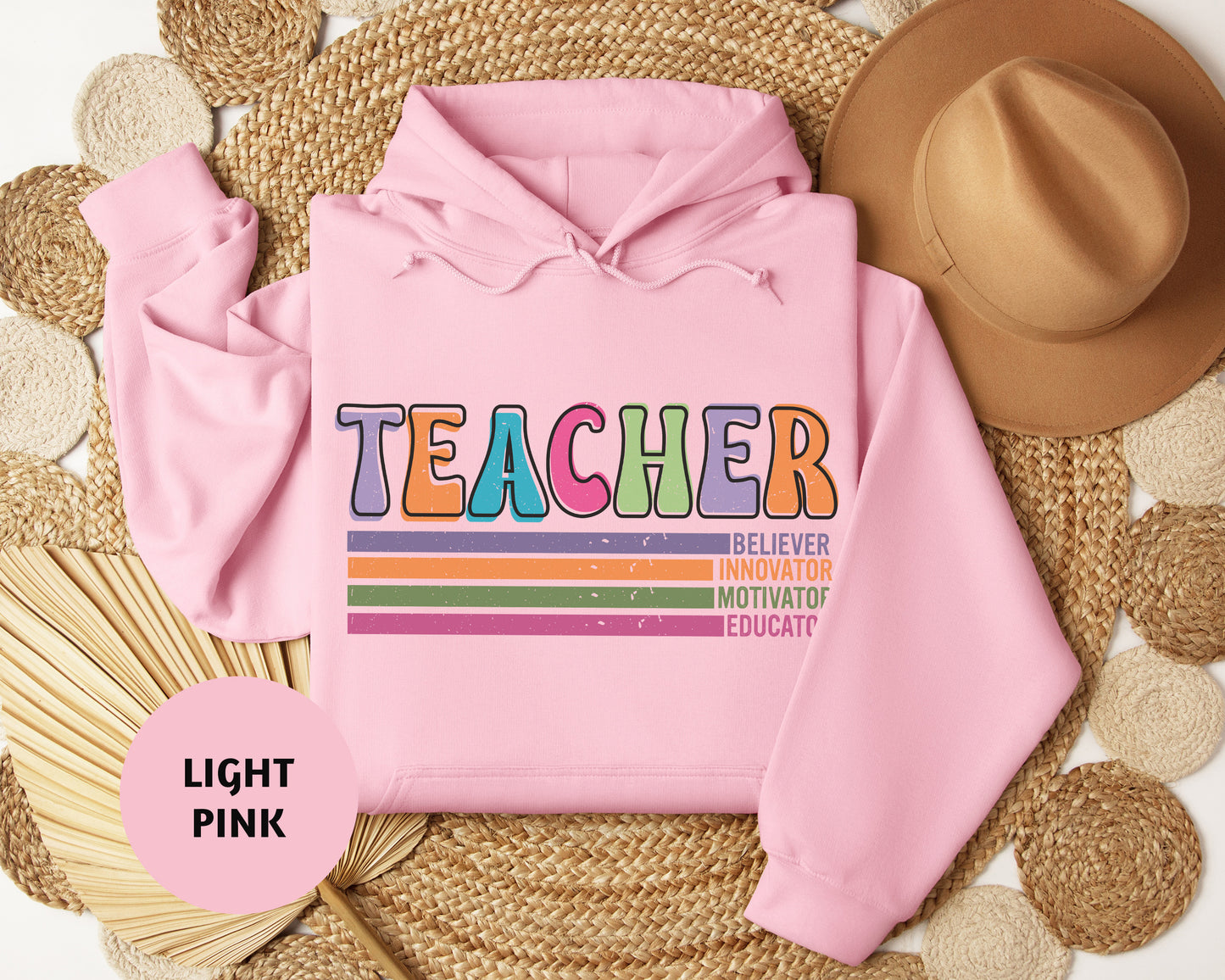a pink hoodie with the words teacher on it
