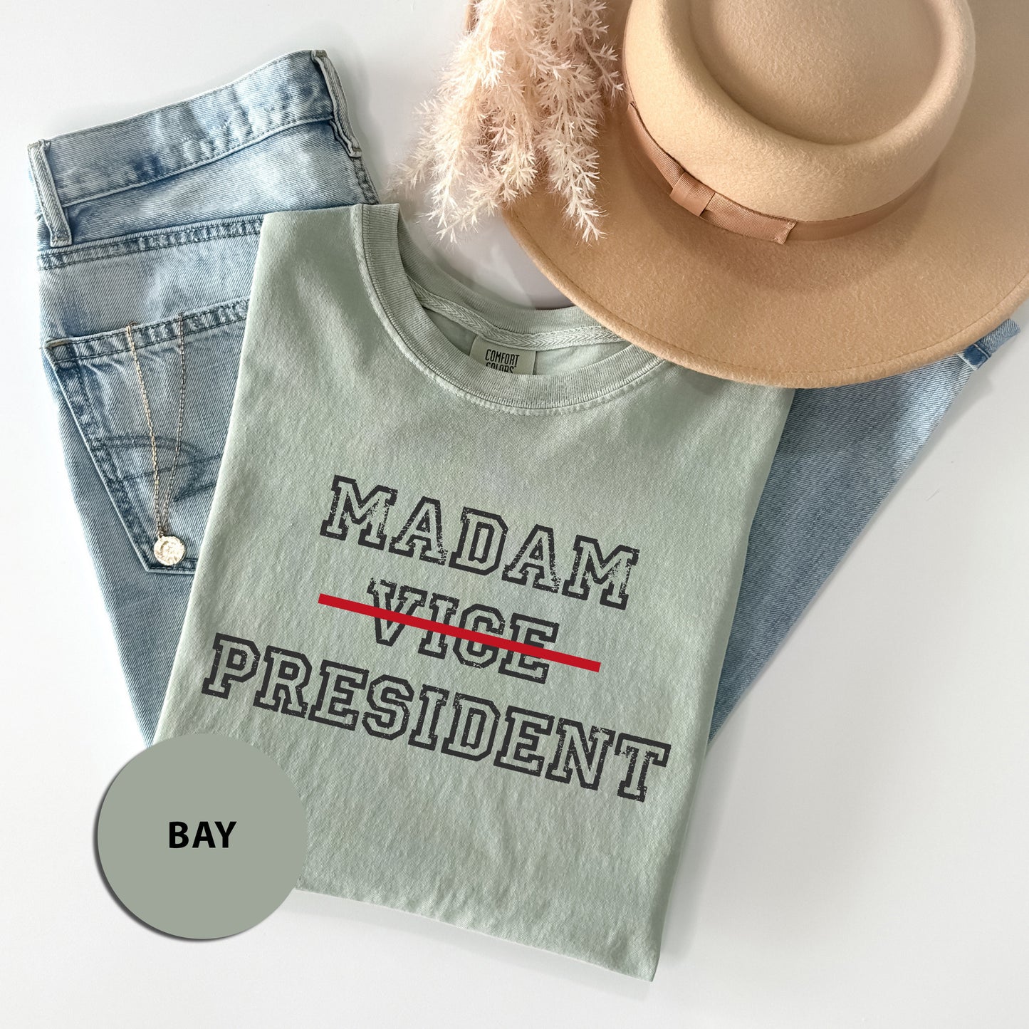 a hat, jeans, and a t - shirt on a white surface