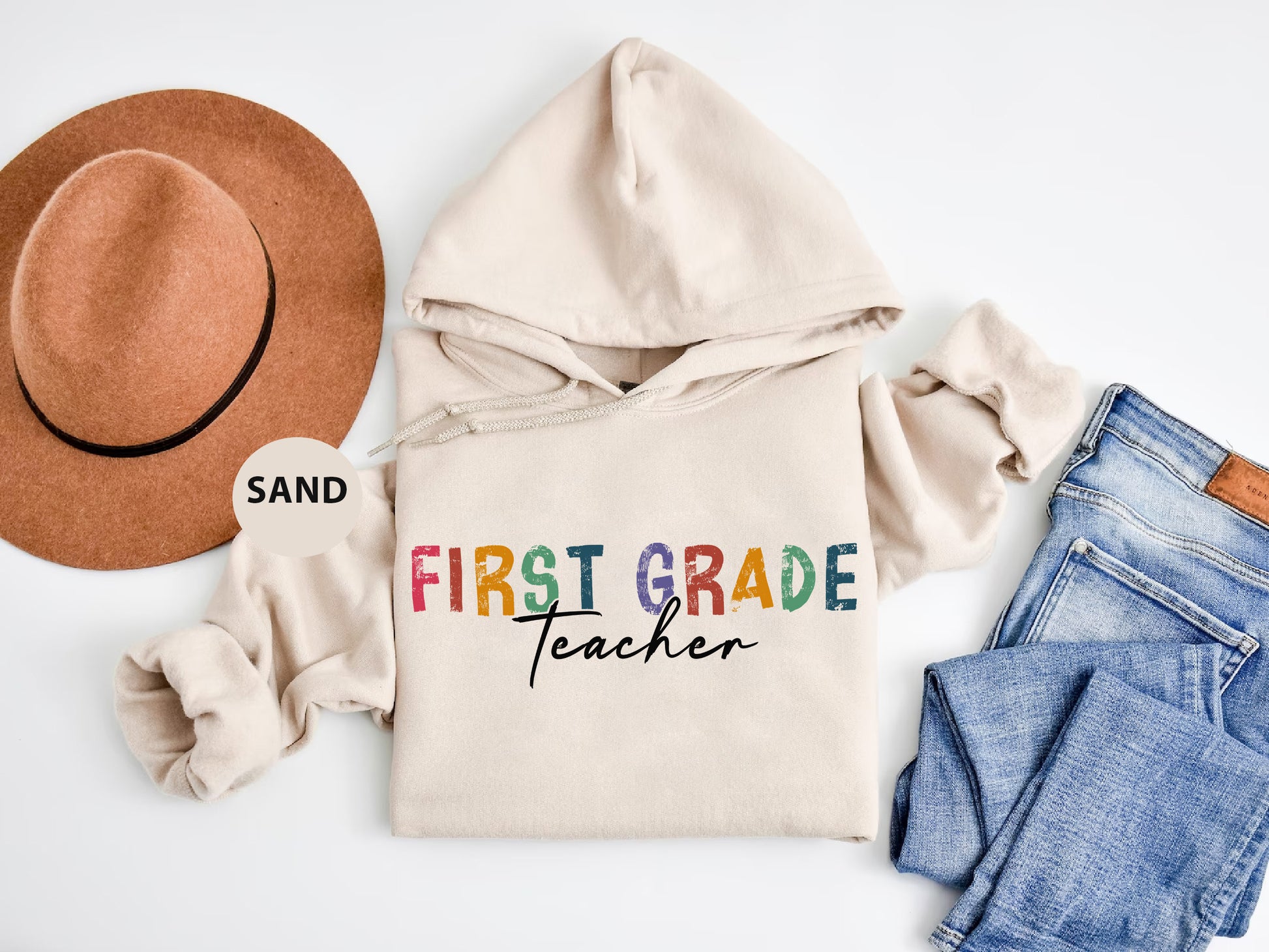 a white shirt with the words first grade teacher on it