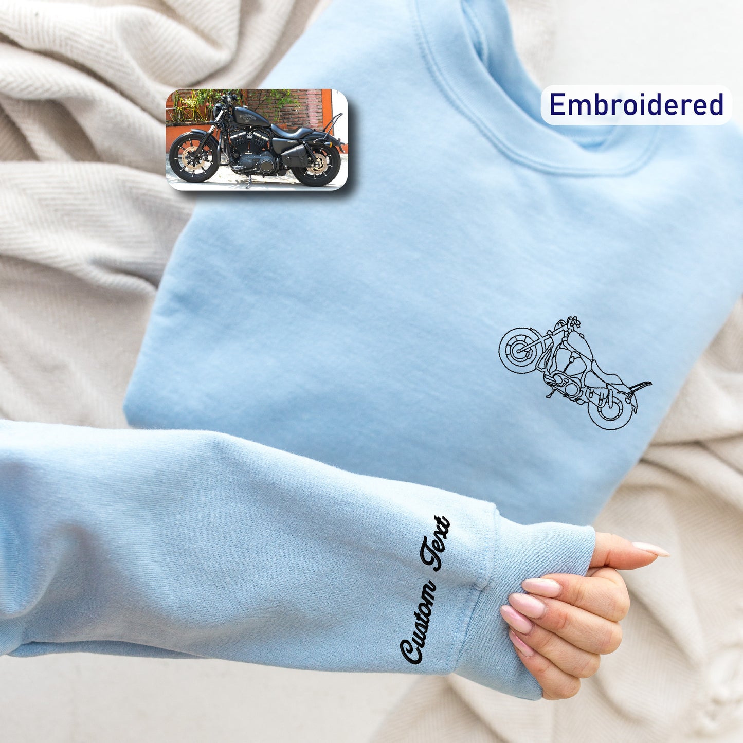 a person wearing a blue sweatshirt with a motorcycle drawn on it