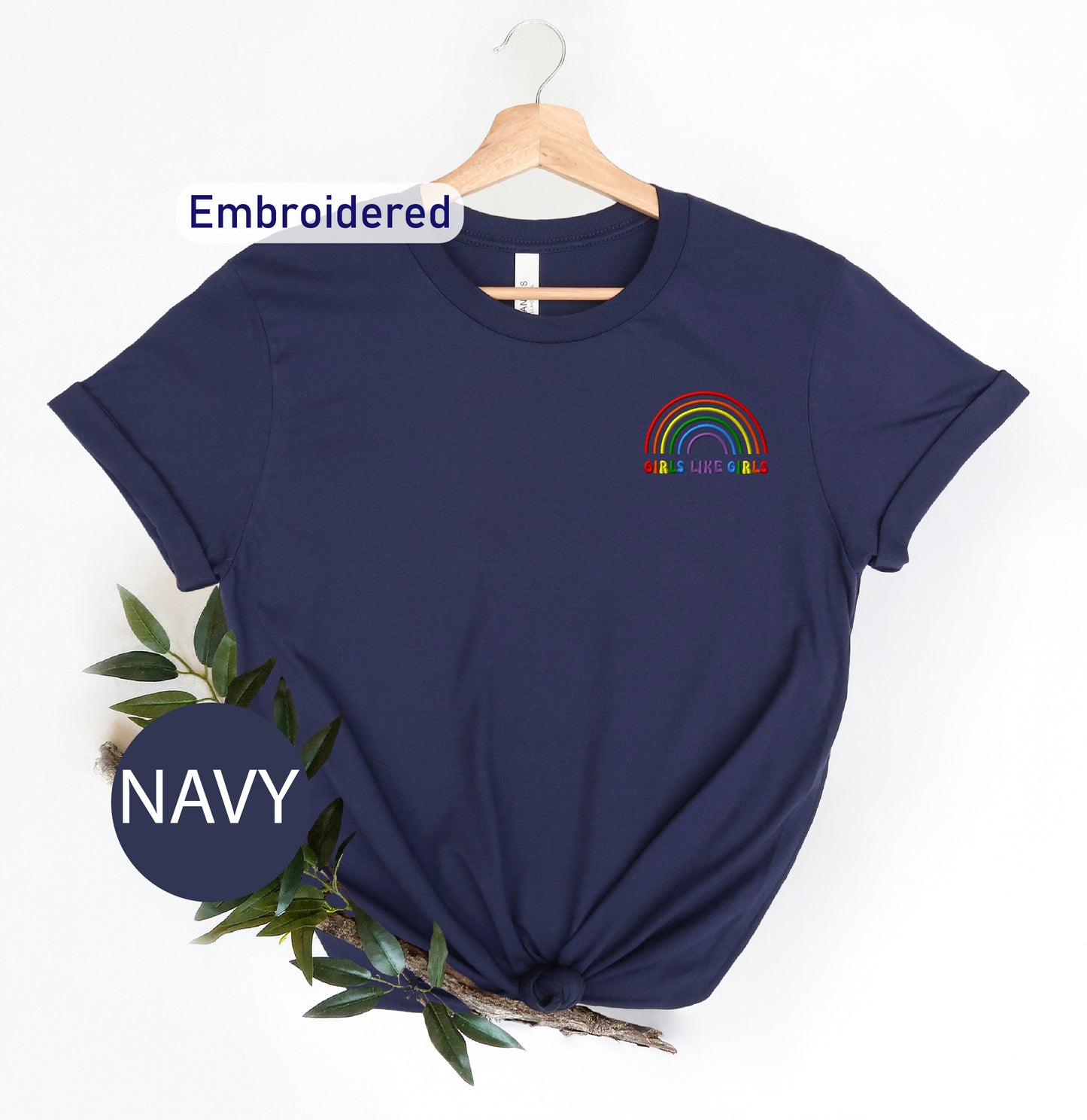 a navy t - shirt with a rainbow embroidered on it