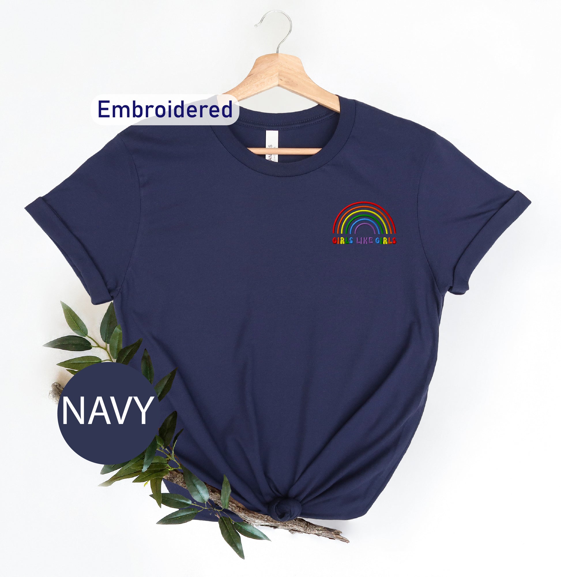 a navy t - shirt with a rainbow embroidered on it