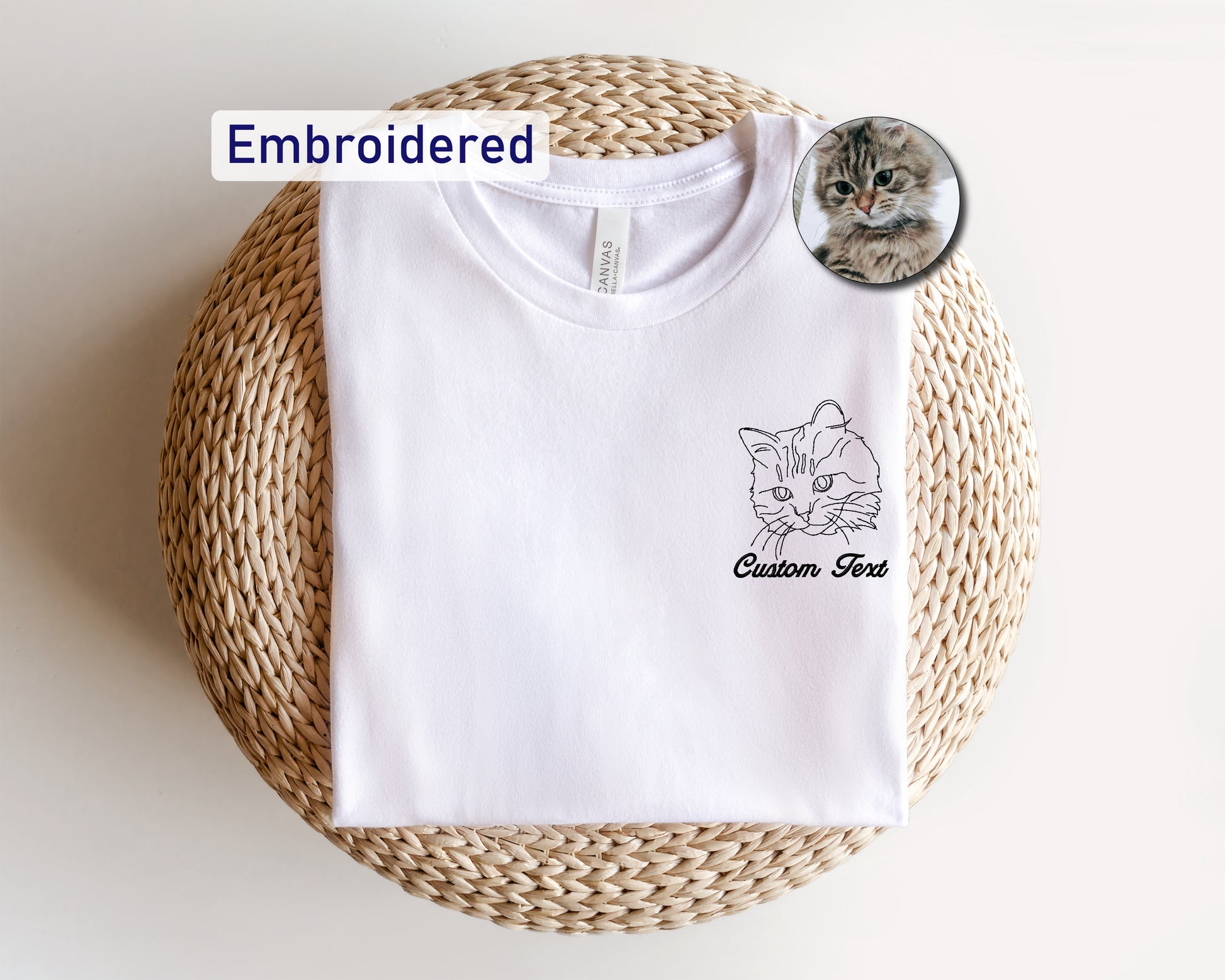 a white t - shirt with a picture of a cat on it