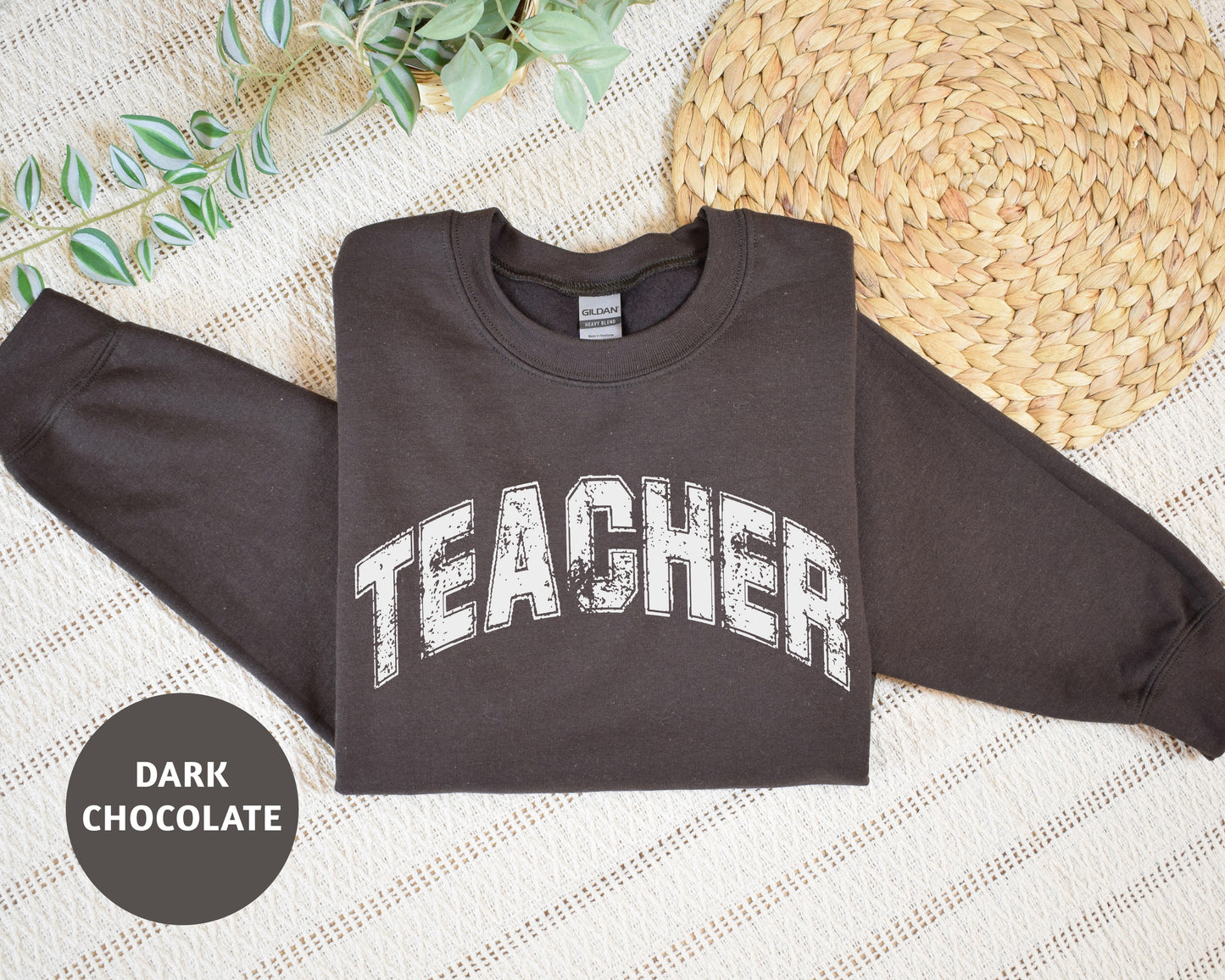 a brown sweatshirt with the word teacher on it