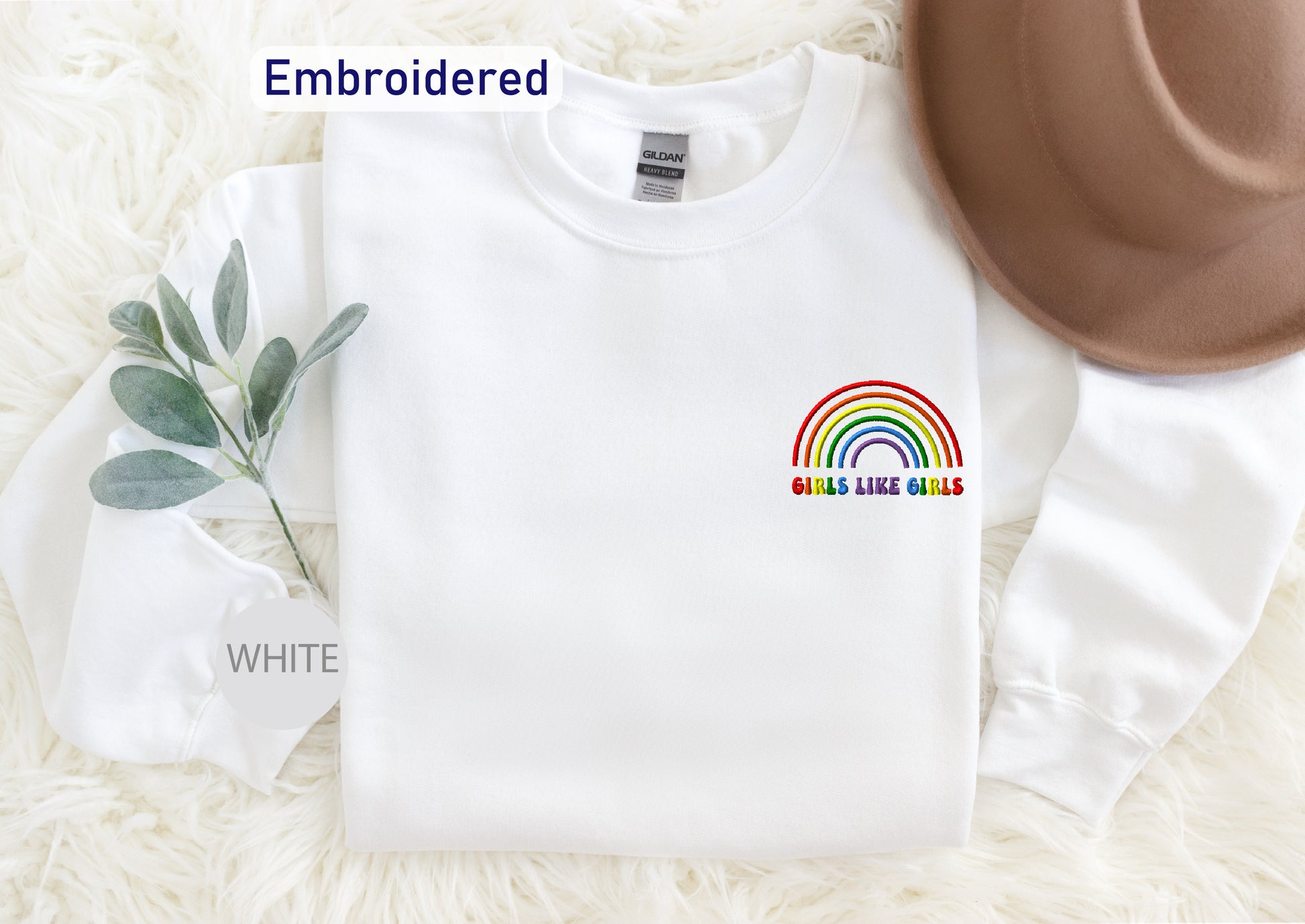 a white sweatshirt with a rainbow on it