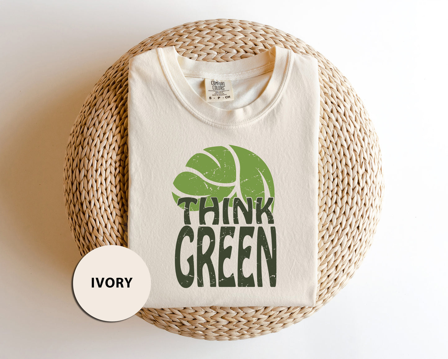 a white t - shirt with a green tennis ball on it
