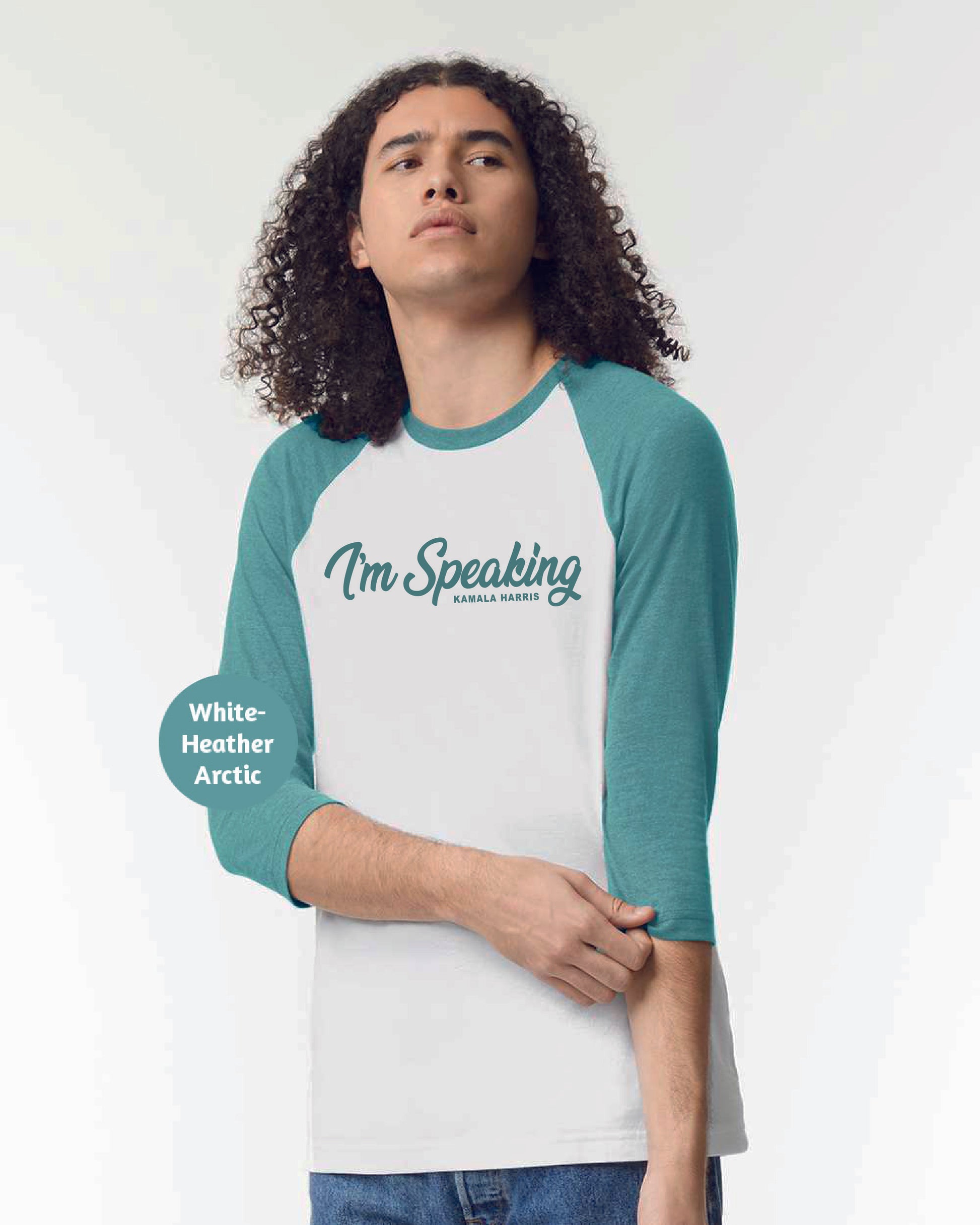 a man with long curly hair wearing a green and white shirt