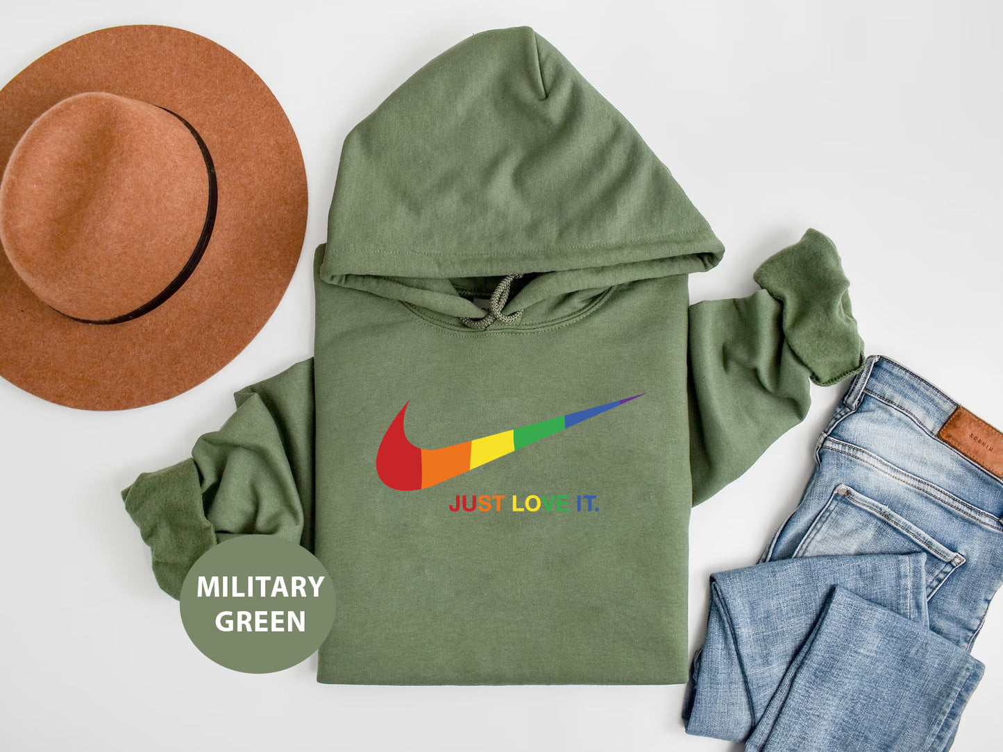 a military green hoodie with a hat and jeans
