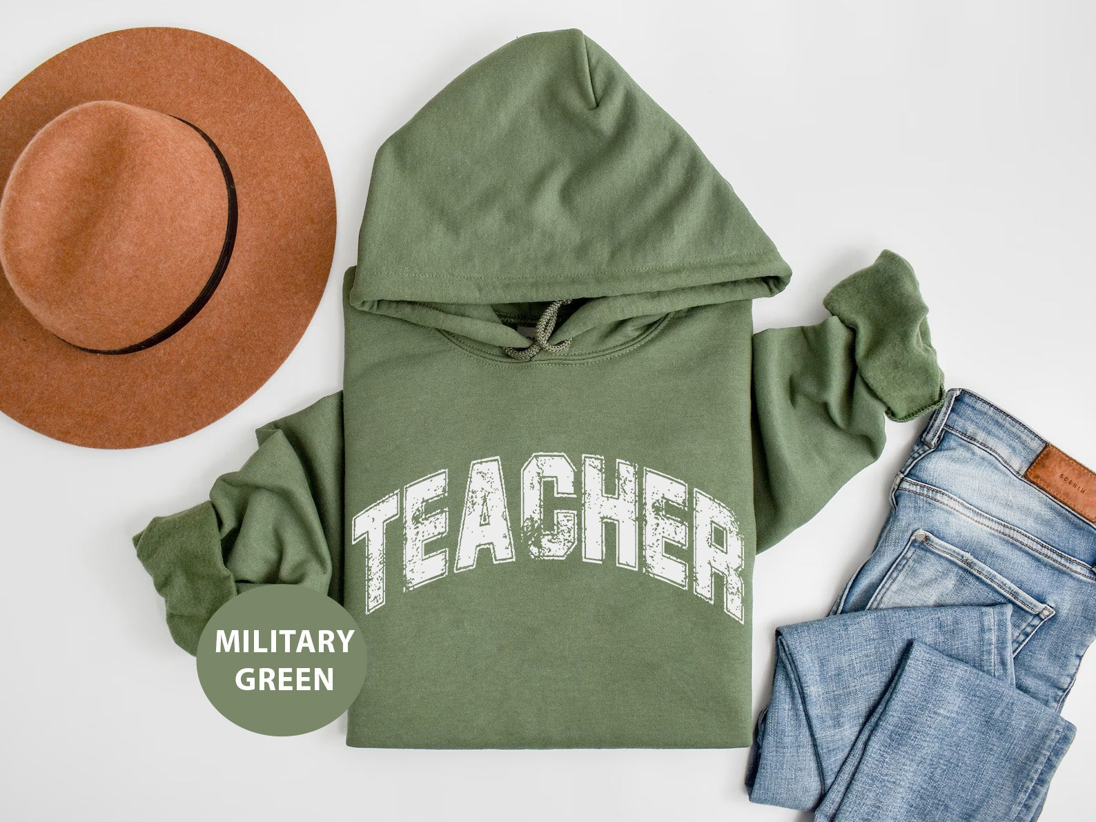 a green hoodie, jeans, hat, and a pair of jeans