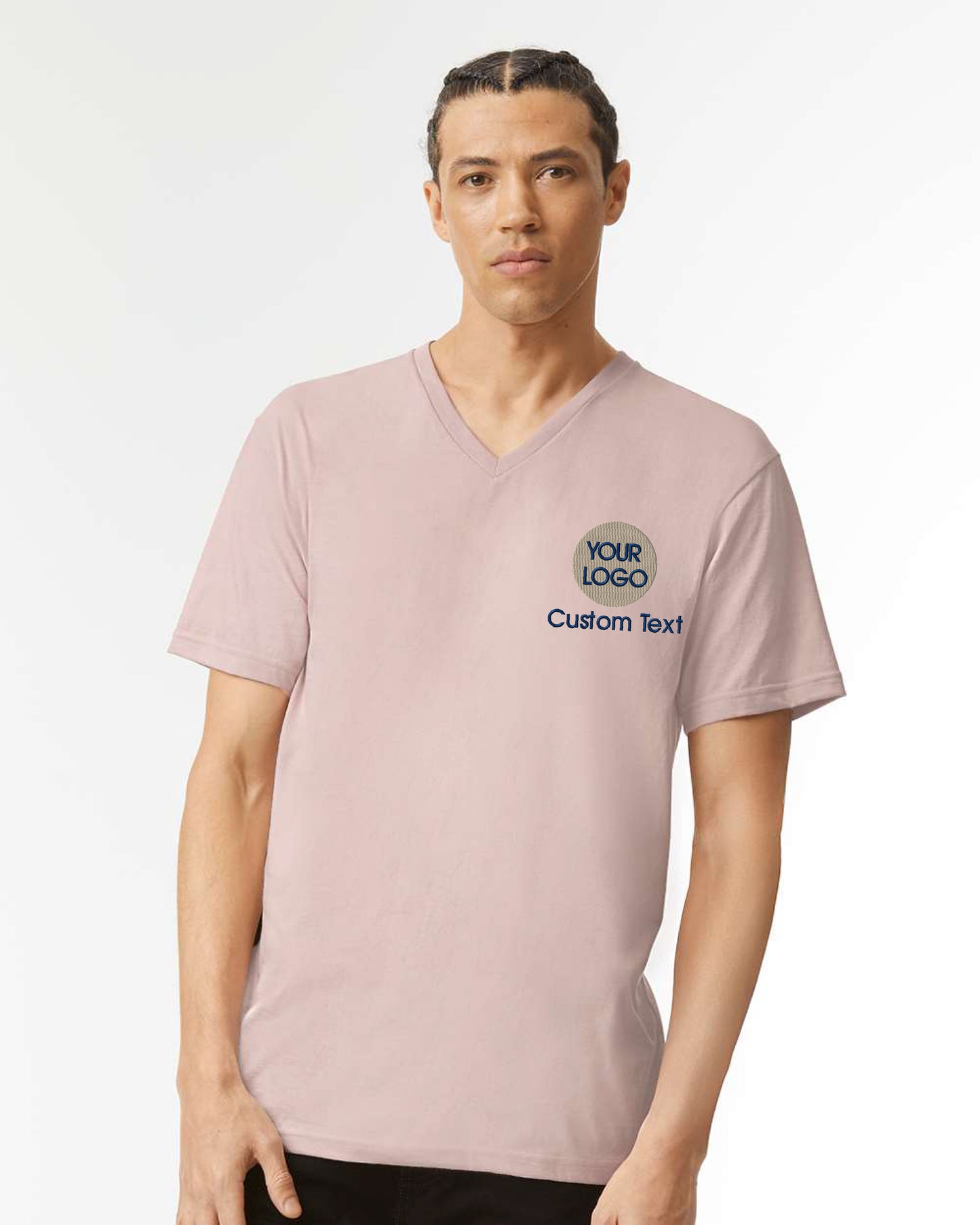 a man wearing a pink shirt with a logo on it