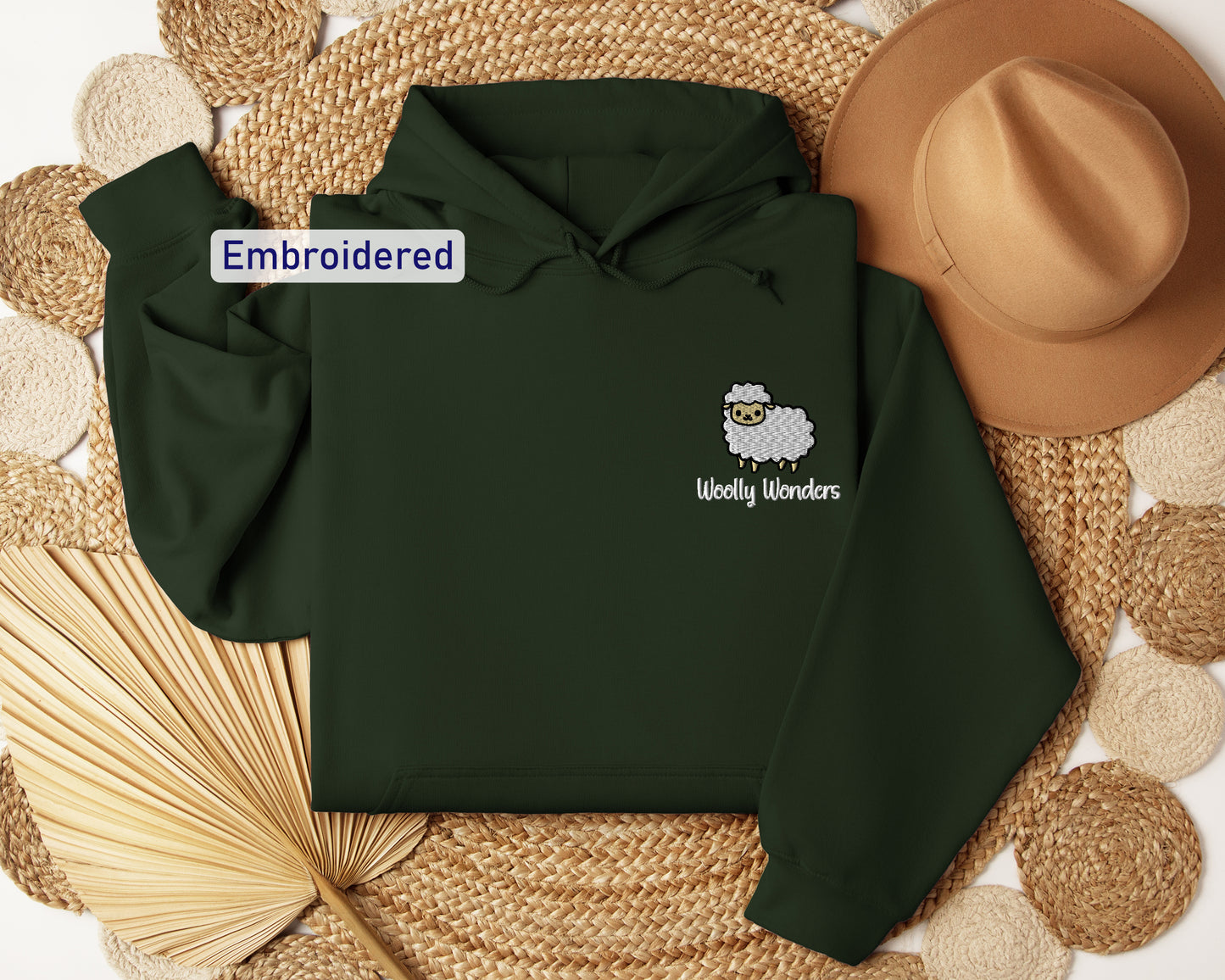 a green hoodie with a sheep embroidered on it