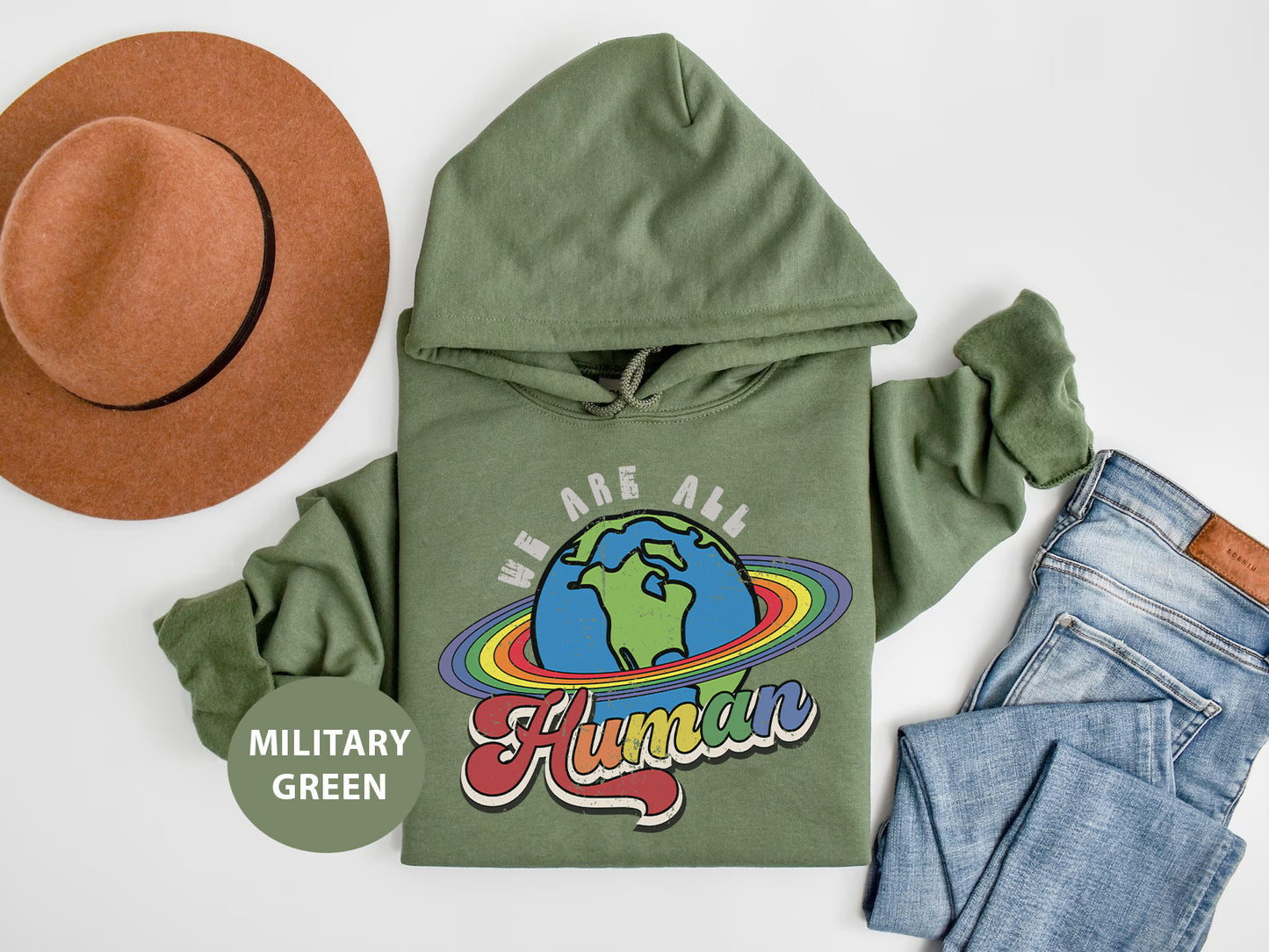 a green hoodie with a hat and a pair of jeans