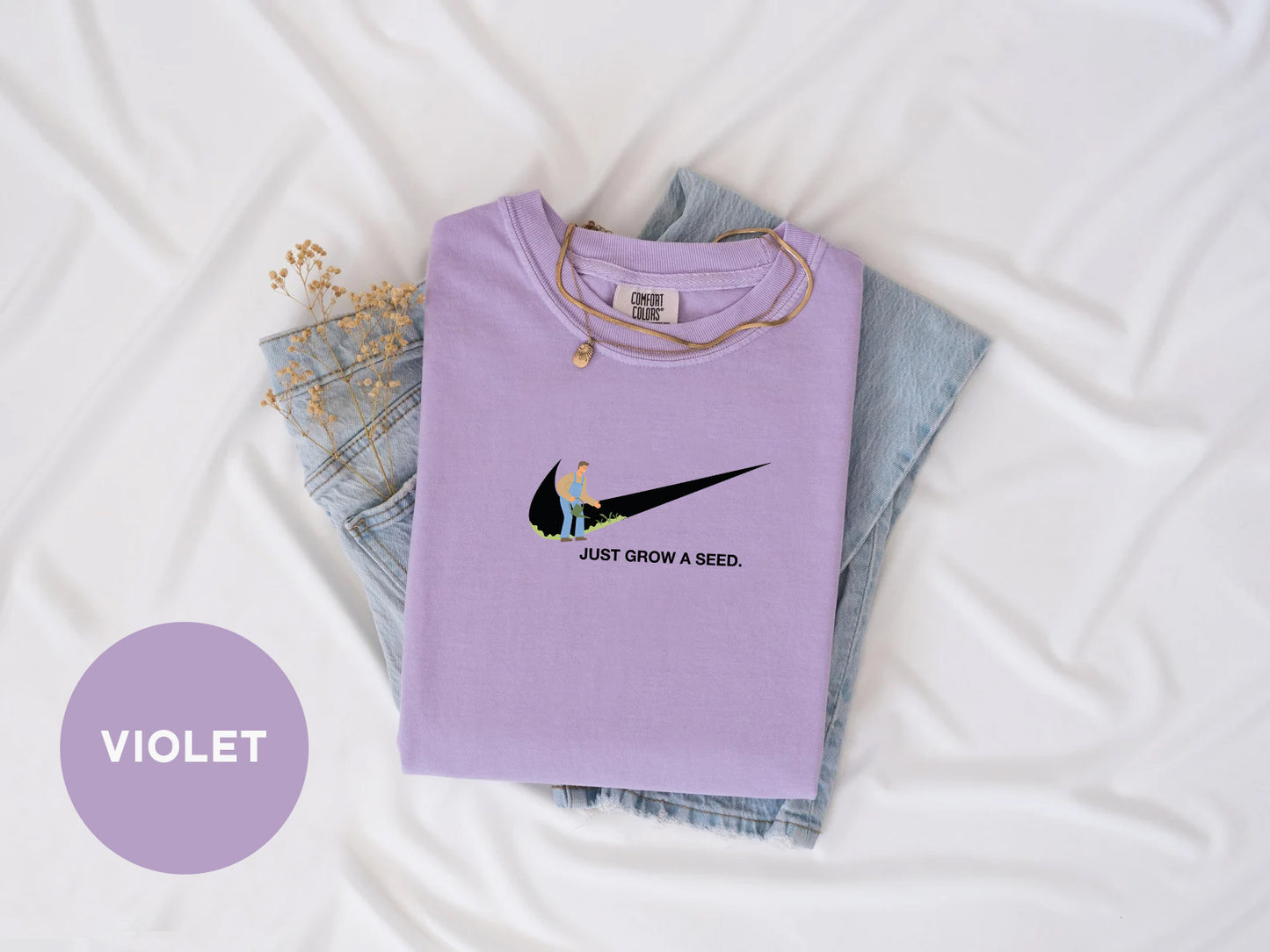 a purple shirt with a bird on it
