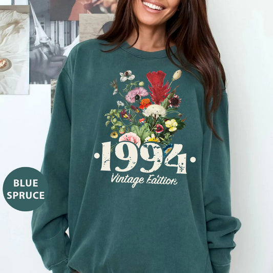 a woman wearing a green sweatshirt with flowers on it